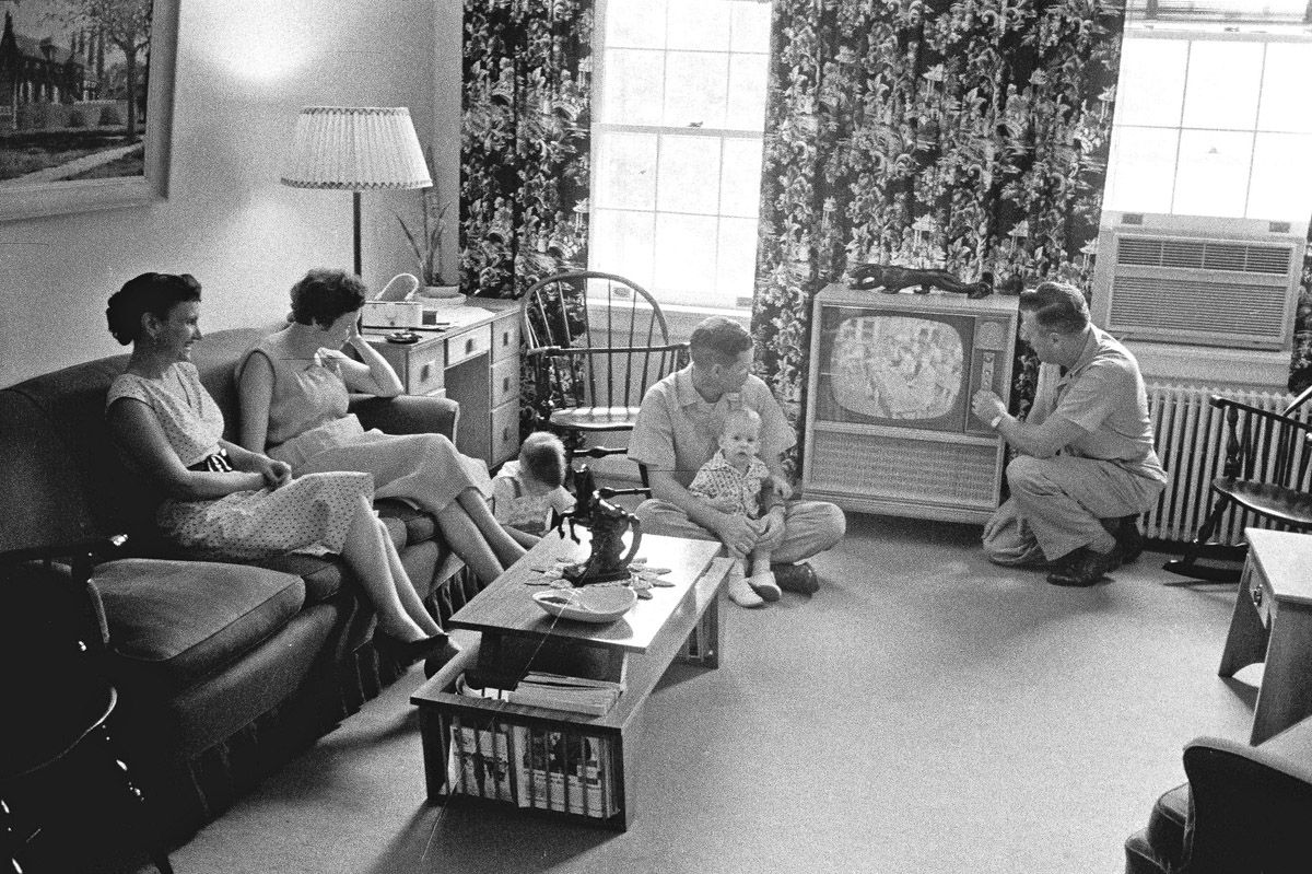 An American family gathered around a vintage TV