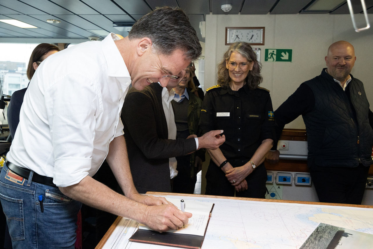 NATO Secretary General Mark Rutte signing the guestbook at the Swedish Coast Guard Ship Amfitrite