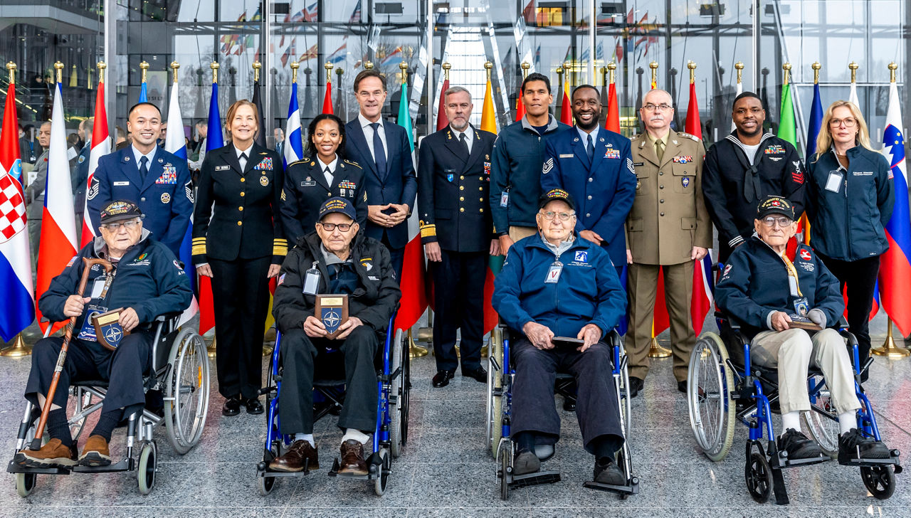 Mark Rutte, NATO Secretary General, Rob Bauer, NATO CMC and Shoshana Simone Chatfield, US Military Representative at NATO, meet with US World War II veterans CPL John D. Foy, SSGT George K. Mullins, CPL Joseph R. Picard and PFC Fred J Nungesser Jr.