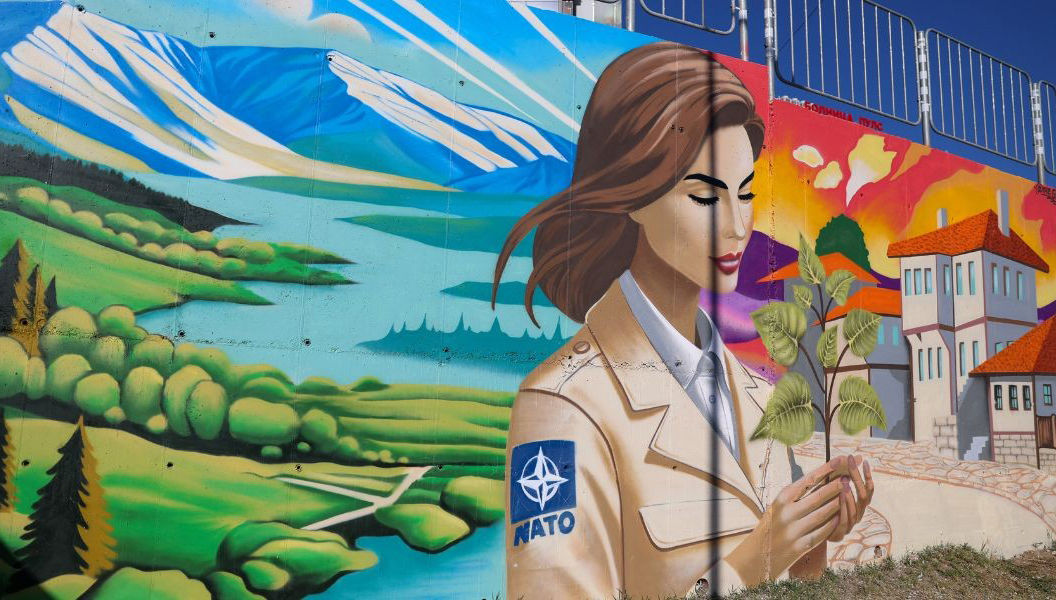 As part of Bulgaria’s celebrations for its 20th anniversary of NATO membership, the Ministry of Foreign Affairs organised a street art competition called “Bulgaria – More Beautiful in NATO”. On 7 November 2024, the first of five graffiti art murals was unveiled in Blagoevgrad. Created by graffiti studio The Graffs, the mural depicts a young soldier with a NATO badge on her shoulder. The soldier is holding a sprouting plant and is surrounded by serene mountains and a colourful cityscape. (Photo credit: Bulgarian Ministry of Foreign Affairs)