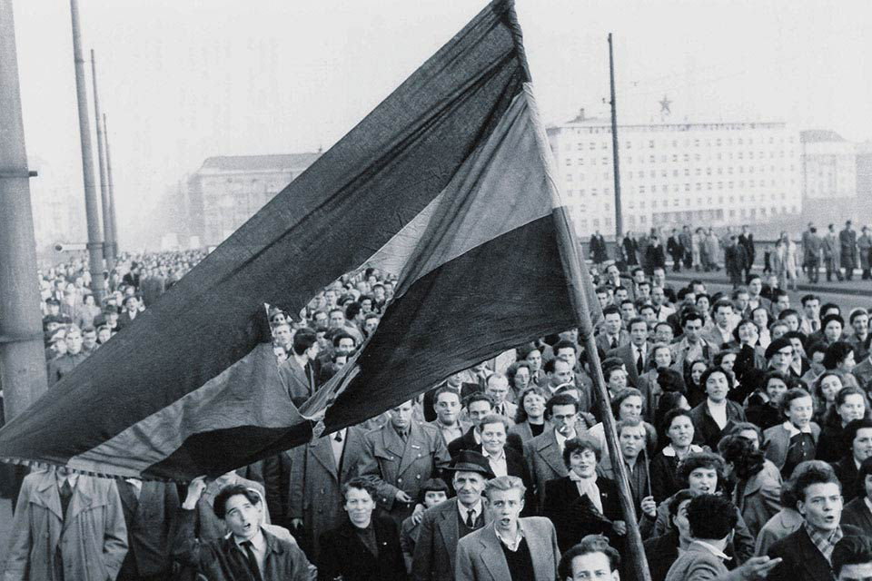 Crowd holding a flag during the 1956 Hungarian uprising
