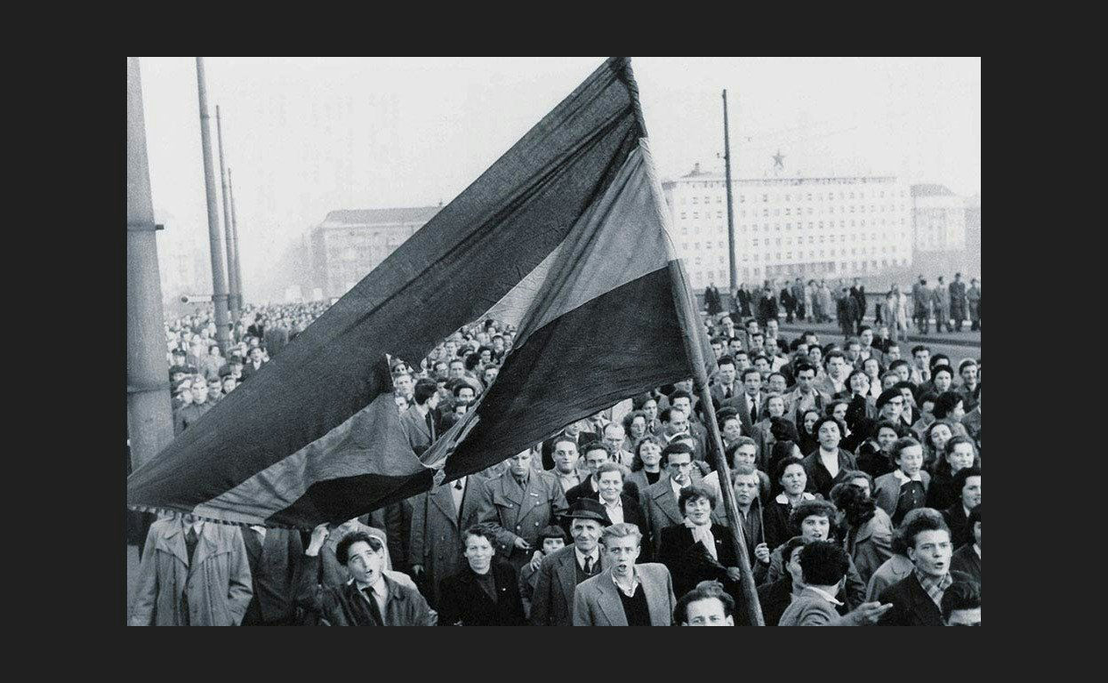 Crowd holding a flag during the 1956 Hungarian uprising