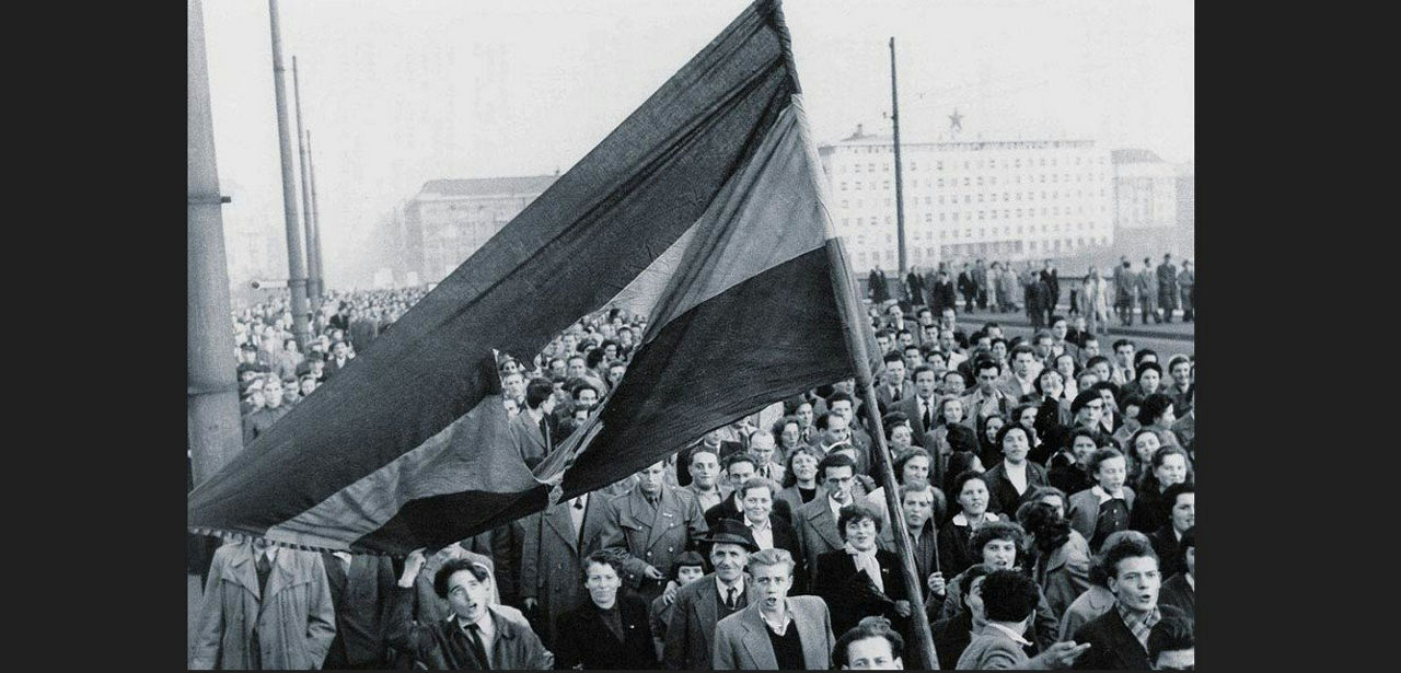 Crowd holding a flag during the 1956 Hungarian uprising