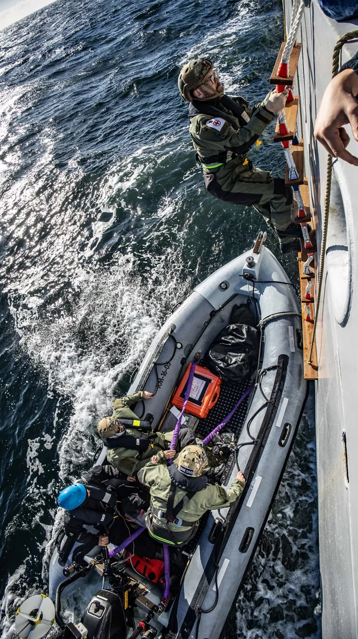 Member of Distressed Sub Group (DSG) climbs down to RIB boat from HNLMS Mercuur during Dynamic Monarch 24.

At Dynamic Monarch 24, the world’s most challenging submarine rescue exercise, Allies are testing various complex submarine rescue systems. The exercise is designed to practise interoperability among naval forces and streamline rescue operations in the most challenging of environments where reaction time and specialist equipment are key to saving lives. Dynamic Monarch 24 is taking place off the coast of Norway.