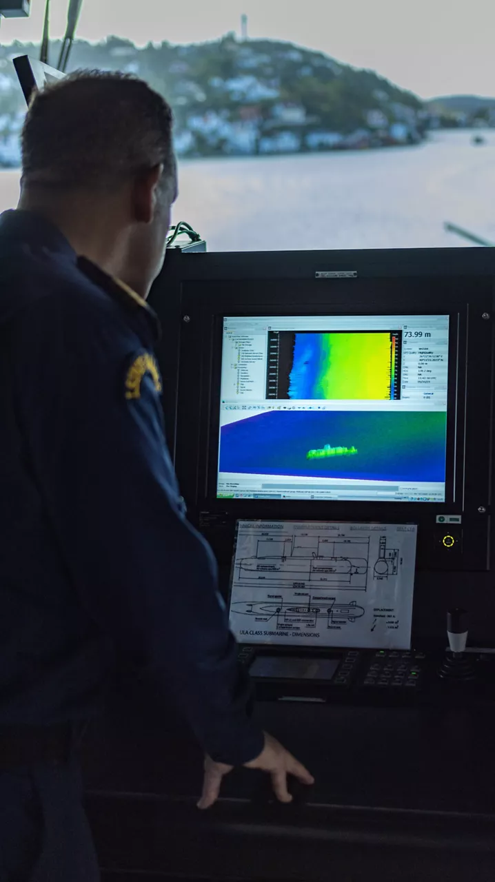 LCDR Okan Erdem, Commanding officer of TCG Alemdar, demonstrates sonar equipment used to find distressed submarines on board the ship during Dynamic Monarch 24.

At Dynamic Monarch 24, the world’s most challenging submarine rescue exercise, Allies are testing various complex submarine rescue systems. The exercise is designed to practise interoperability among naval forces and streamline rescue operations in the most challenging of environments where reaction time and specialist equipment are key to saving lives. Dynamic Monarch 24 is taking place off the coast of Norway.

