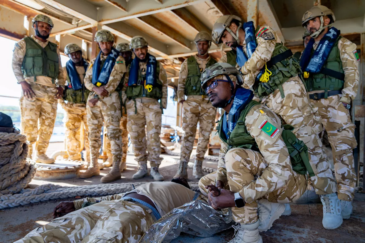 NATO trainer instructs Mauritanian sailors in first aid techniques.

Sailors of the Mauritanian Navy conducted a three week-training programme on maritime security operations, hosted by the NATO Maritime Interdiction Operational Training Centre (NMIOTC), located near Chania, Greece, from 21 October to 8 November 2024. These training activities were carried out within the framework of NATO’s Defence and Related Security Capacity Building (DCB) Initiative.

