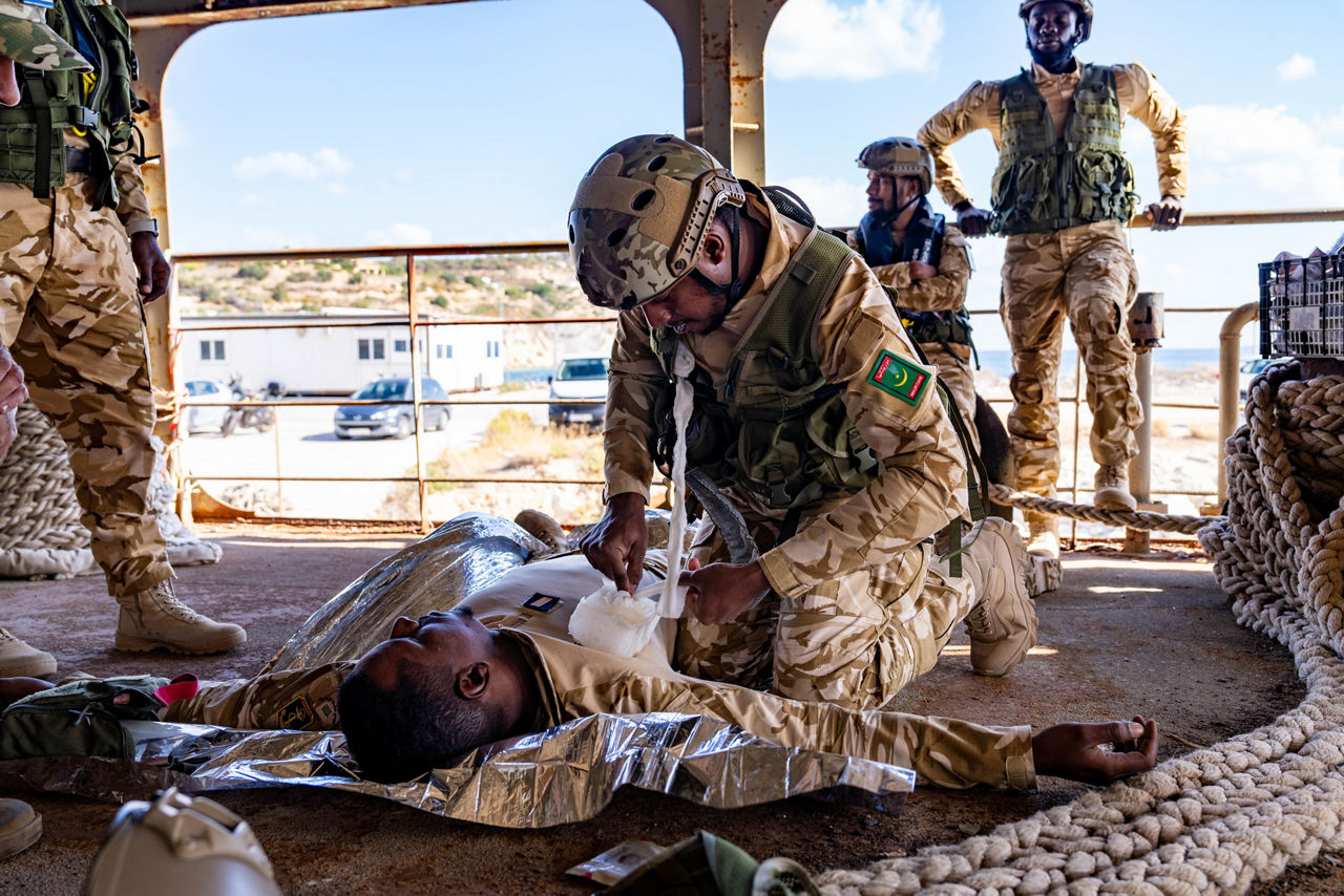 Mauritanian sailors practice first aid techniques in a course led by NATO instructors.



Sailors of the Mauritanian Navy conducted a three week-training programme on maritime security operations, hosted by the NATO Maritime Interdiction Operational Training Centre (NMIOTC), located near Chania, Greece, from 21 October to 8 November 2024. These training activities were carried out within the framework of NATO’s Defence and Related Security Capacity Building (DCB) Initiative.

