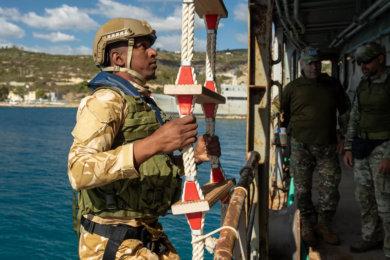 Mauritanian sailor ascends ladder during fast boat (RHIB) approach drills.

Sailors of the Mauritanian Navy conducted a three week-training programme on maritime security operations, hosted by the NATO Maritime Interdiction Operational Training Centre (NMIOTC), located near Chania, Greece, from 21 October to 8 November 2024. These training activities were carried out within the framework of NATO’s Defence and Related Security Capacity Building (DCB) Initiative.

