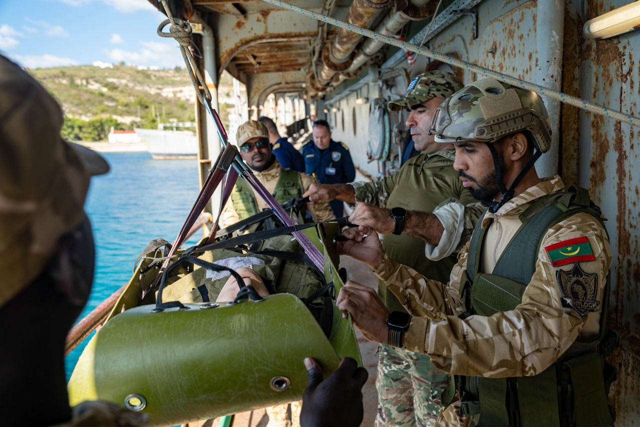 Mauritanian sailors conduct medical evacuation drills during a training exercise.



Sailors of the Mauritanian Navy conducted a three week-training programme on maritime security operations, hosted by the NATO Maritime Interdiction Operational Training Centre (NMIOTC), located near Chania, Greece, from 21 October to 8 November 2024. These training activities were carried out within the framework of NATO’s Defence and Related Security Capacity Building (DCB) Initiative.

