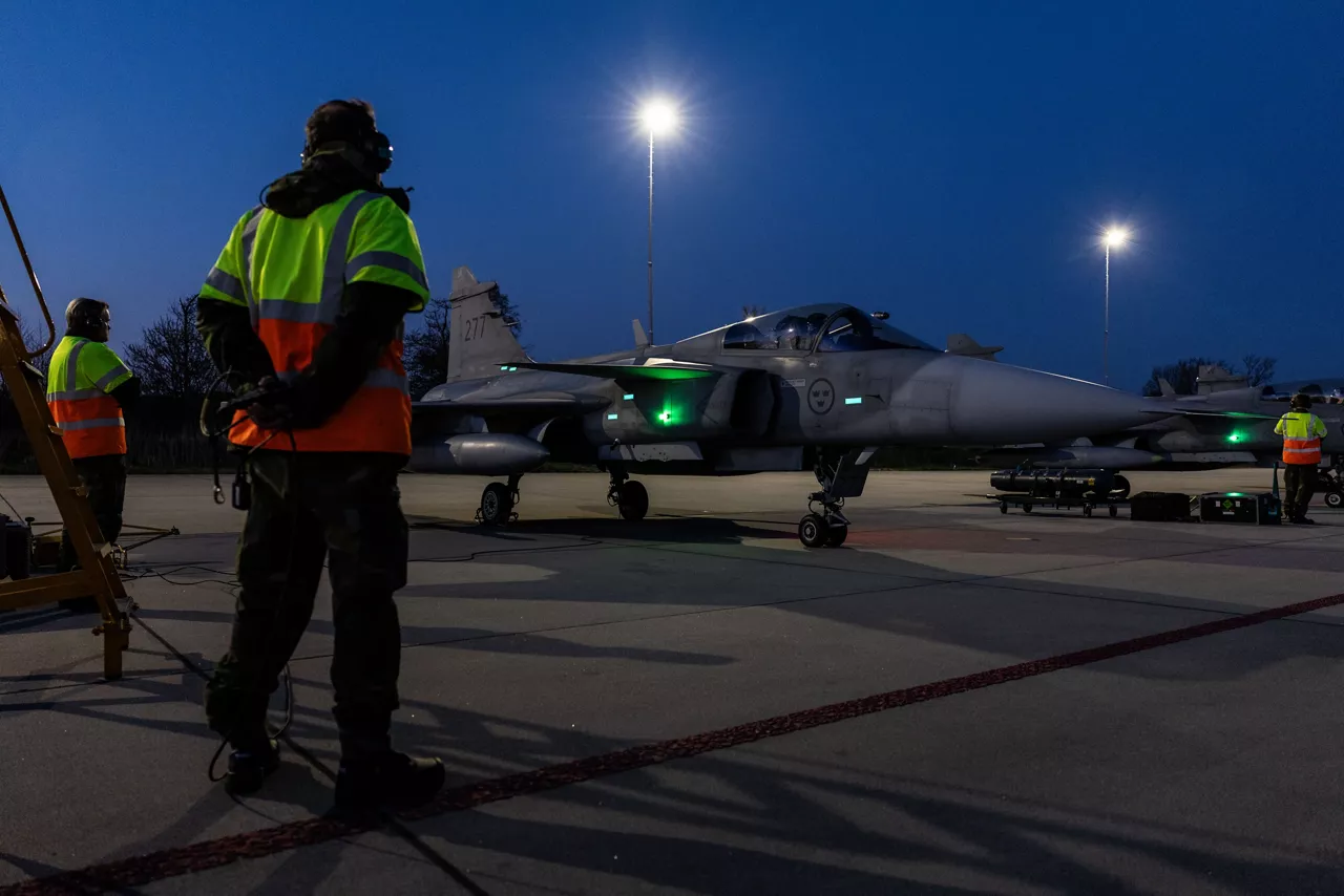 Ground crew from the Swedish Air Force stand by as JAS 39 Gripen fighters prepare to taxi for takeoff at Leeuwarden Air Base in the Netherlands during exercise Ramstein Flag 25. 

With over 90 aircraft from 15 NATO Allies flying out of 12 Allied air bases throughout Europe, the exercise tests NATO’s ability to perform a broad variety of air combat missions using multinational forces.