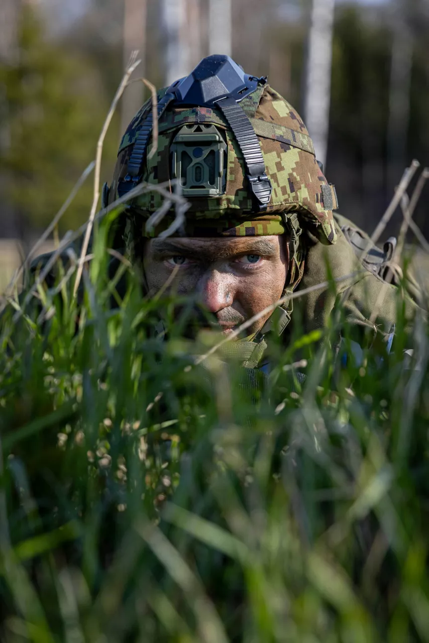 A close-up of an Estonian soldier as he looks through the grass during exercise training. 

Estonia hosted one of the largest military exercises in its history. Known as exercise Hedgehog 25 — or Siil 2025 in Estonian — the operation saw 16,000 troops take part in a sweeping, multinational defence drill that spans the entire country.  It’s a test of how Estonia and other NATO Allies would respond together in the face of a crisis.
