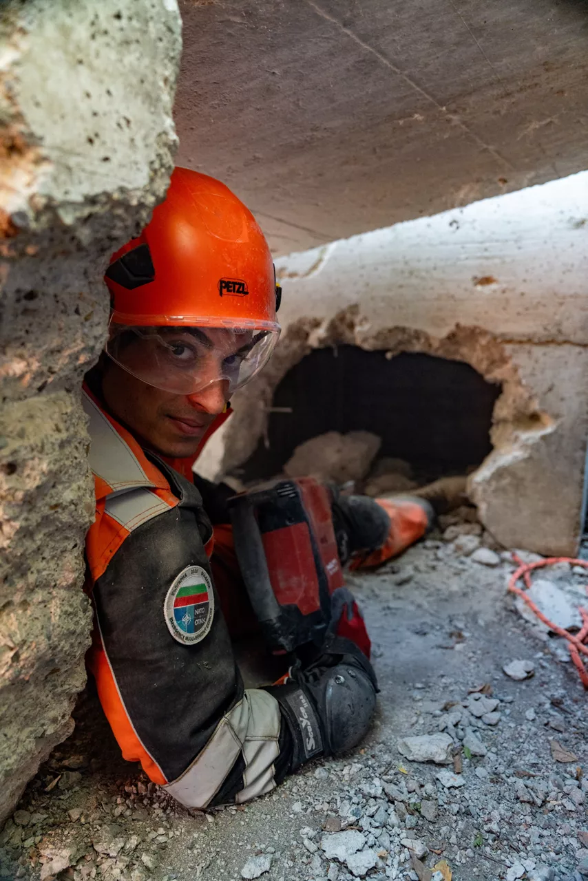 A member of the Turkish emergency search and rescue unit looks toward the camera during an urban rescue training exercise.

In one of the year’s largest and most complex civil emergency exercises, soldiers, scientists, and first responders trained in Bulgaria to strengthen coordination and readiness for large-scale disasters. The exercise, “Bulgaria 2025”, took place from 7 until 12 September 2025.