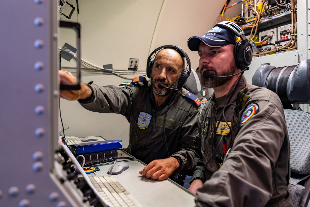 Aircrew from Italy and Romania monitor the communication systems of their E-3A Airborne Warning and Control System (AWACS) aircraft.

The first surveillance flight of NATO’s Airborne Warning and Control System (AWACS) was conducted over NATO’s eastern flank in support of a military activity called “Eastern Sentry” on 19 September 2025. This multi-domain activity is a direct response to recent airspace violations — including the incursion of multiple Russian drones into Polish airspace on 10 September 2025. Eastern Sentry will further strengthen NATO’s posture to shield and protect all Allies.