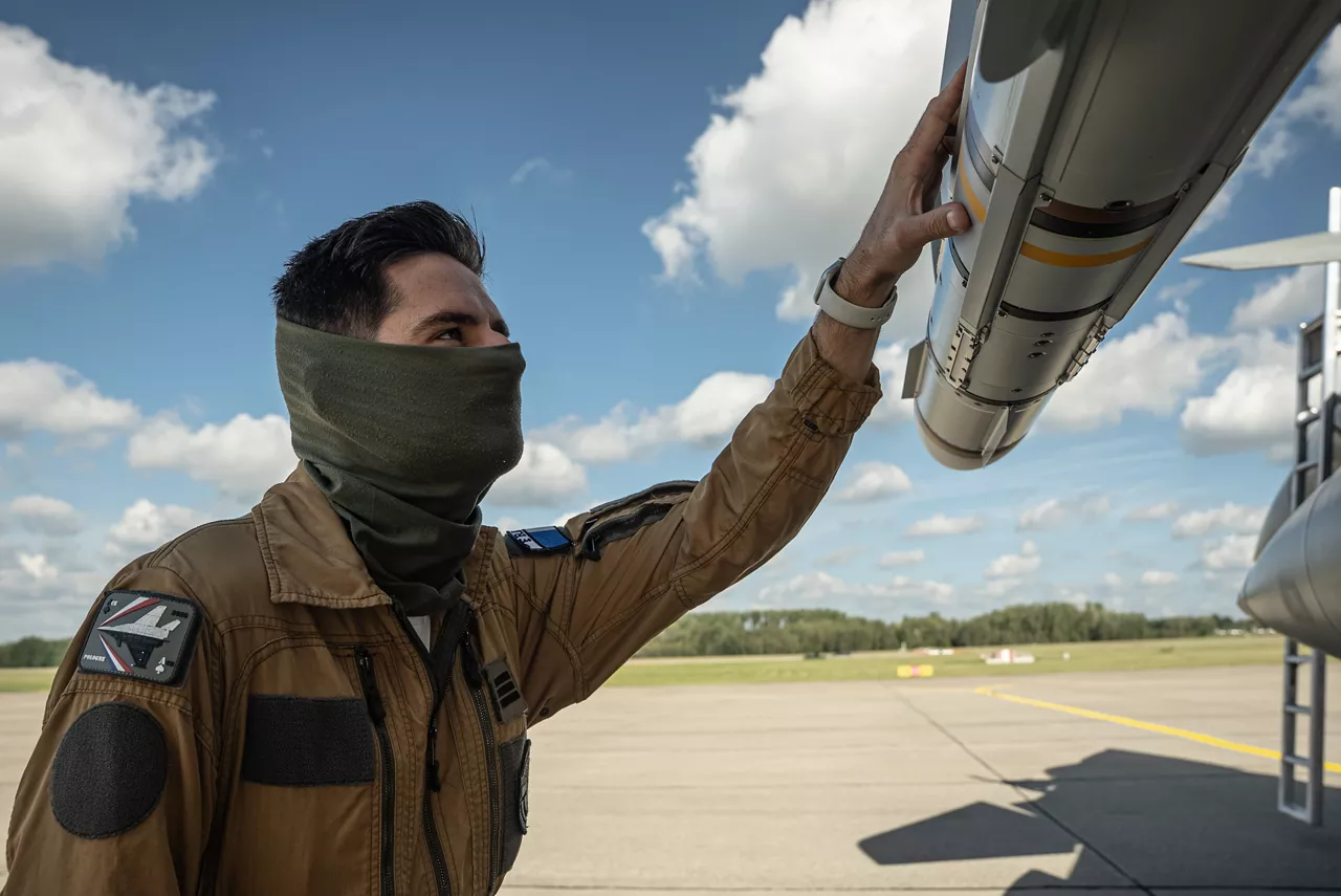 A French Air Force weapons systems officer inspects his jet on the runway of a Polish airbase. In the wake of the intrusion of Russian drones to Polish airspace on 10 September 2025, the French Air Force has deployed three Rafale fighter jets to Poland as part of the new NATO activity “Eastern Sentry”.