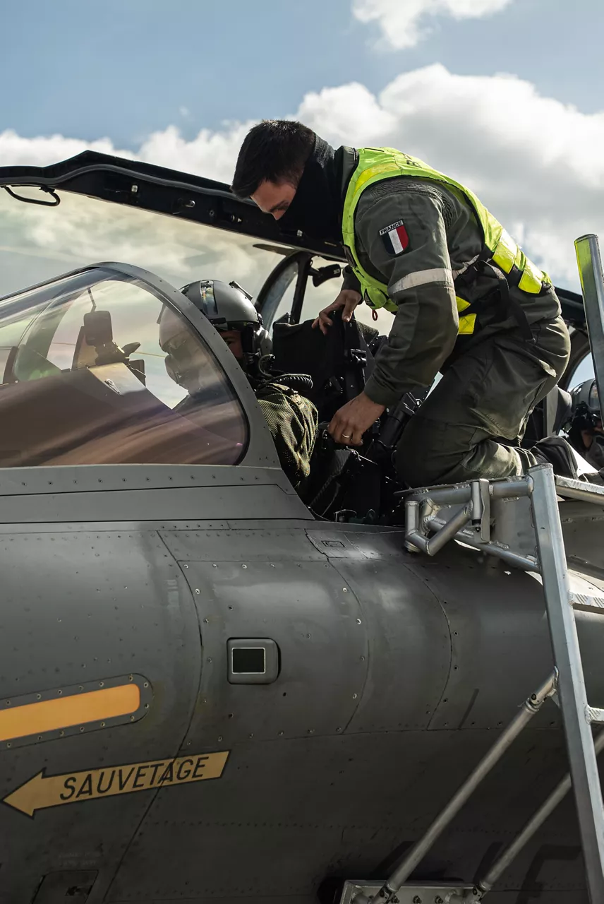 A French Rafale pilot makes some final adjustments alongside ground crew prior to a sheduled takeoff. In the wake of the intrusion of Russian drones to Polish airspace on 10 September 2025, the French Air Force has deployed three Rafale fighter jets to Poland as part of the new NATO activity “Eastern Sentry”.