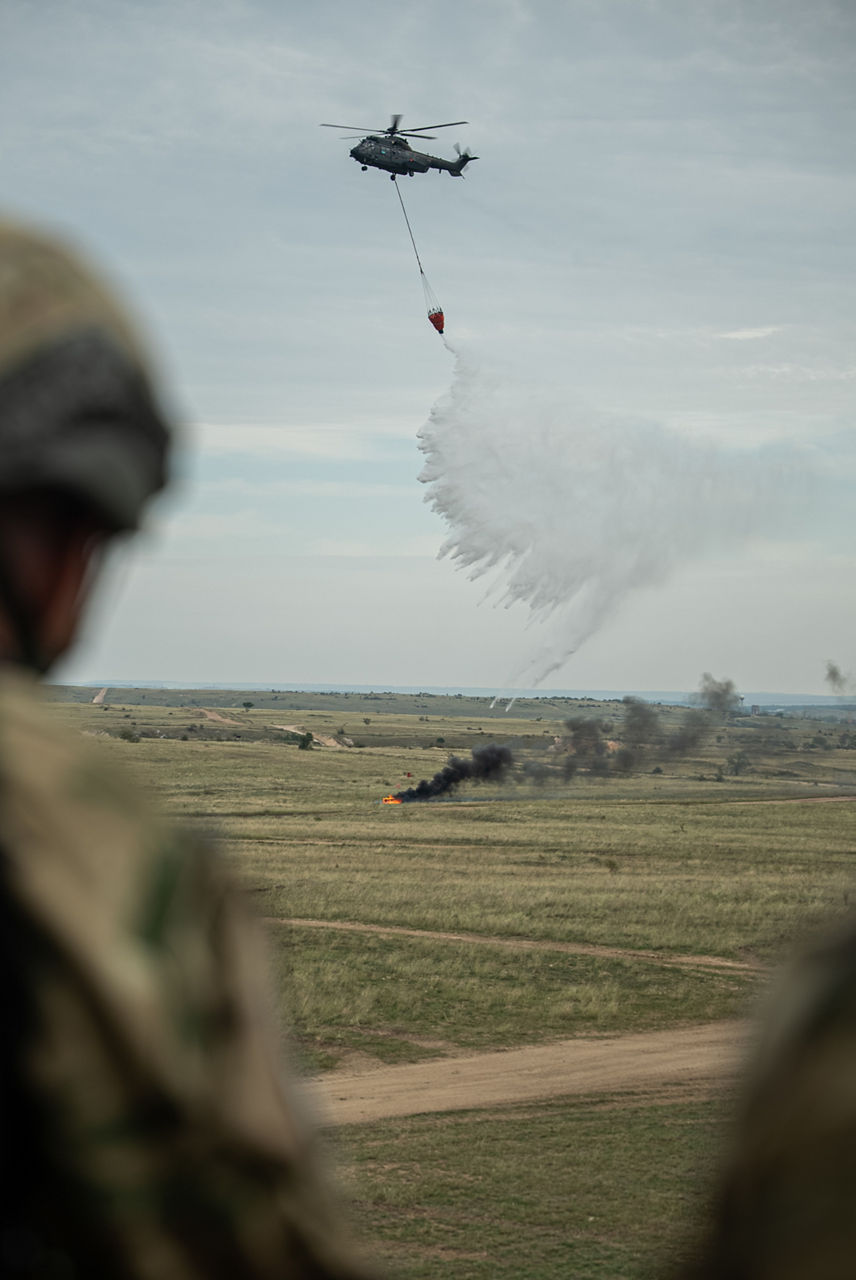 A Hungarian Air Force helicopter drops a bambi bucket on a simulated fire. Exercise Adaptive Hussars 2025 was the Hungarian Defence Forces’ largest and most complex military exercise since Hungary’s accession to NATO in 1999. It promoted cooperation between all NATO members contributing to the NATO’s multinational battlegroup in Hungary, and boosted Hungary’s  defence capabilities along with NATO defence plans and procedures.