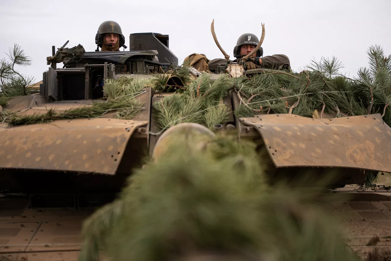 Two Hungarian tankers take a moment to rest on their Leopard tank during Exercise Adaptive Hussar. Exercise Adaptive Hussars 2025 was the Hungarian Defence Forces’ largest and most complex military exercise since Hungary’s accession to NATO in 1999. It promoted cooperation between all NATO members contributing to the NATO’s multinational battlegroup in Hungary, and boosted Hungary’s  defence capabilities along with NATO defence plans and procedures.