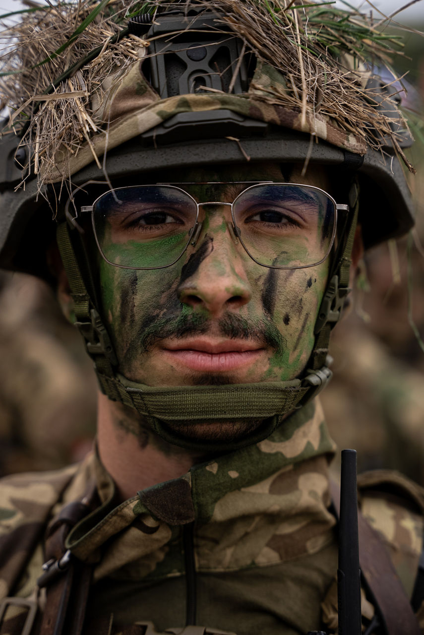 A Hungarian soldier sporting face paint and helmet scrim looks to the camera. Exercise Adaptive Hussars 2025 was the Hungarian Defence Forces’ largest and most complex military exercise since Hungary’s accession to NATO in 1999. It promoted cooperation between all NATO members contributing to the NATO’s multinational battlegroup in Hungary, and boosted Hungary’s  defence capabilities along with NATO defence plans and procedures.