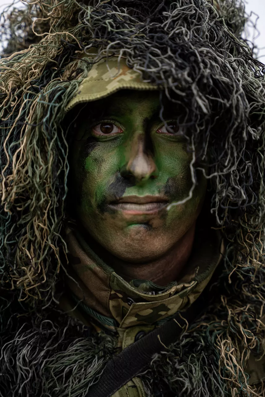 A Hungarian army sniper sporting a full ghillie suit and face camouflage. Exercise Adaptive Hussars 2025 was the Hungarian Defence Forces’ largest and most complex military exercise since Hungary’s accession to NATO in 1999. It promoted cooperation between all NATO members contributing to the NATO’s multinational battlegroup in Hungary, and boosted Hungary’s  defence capabilities along with NATO defence plans and procedures.