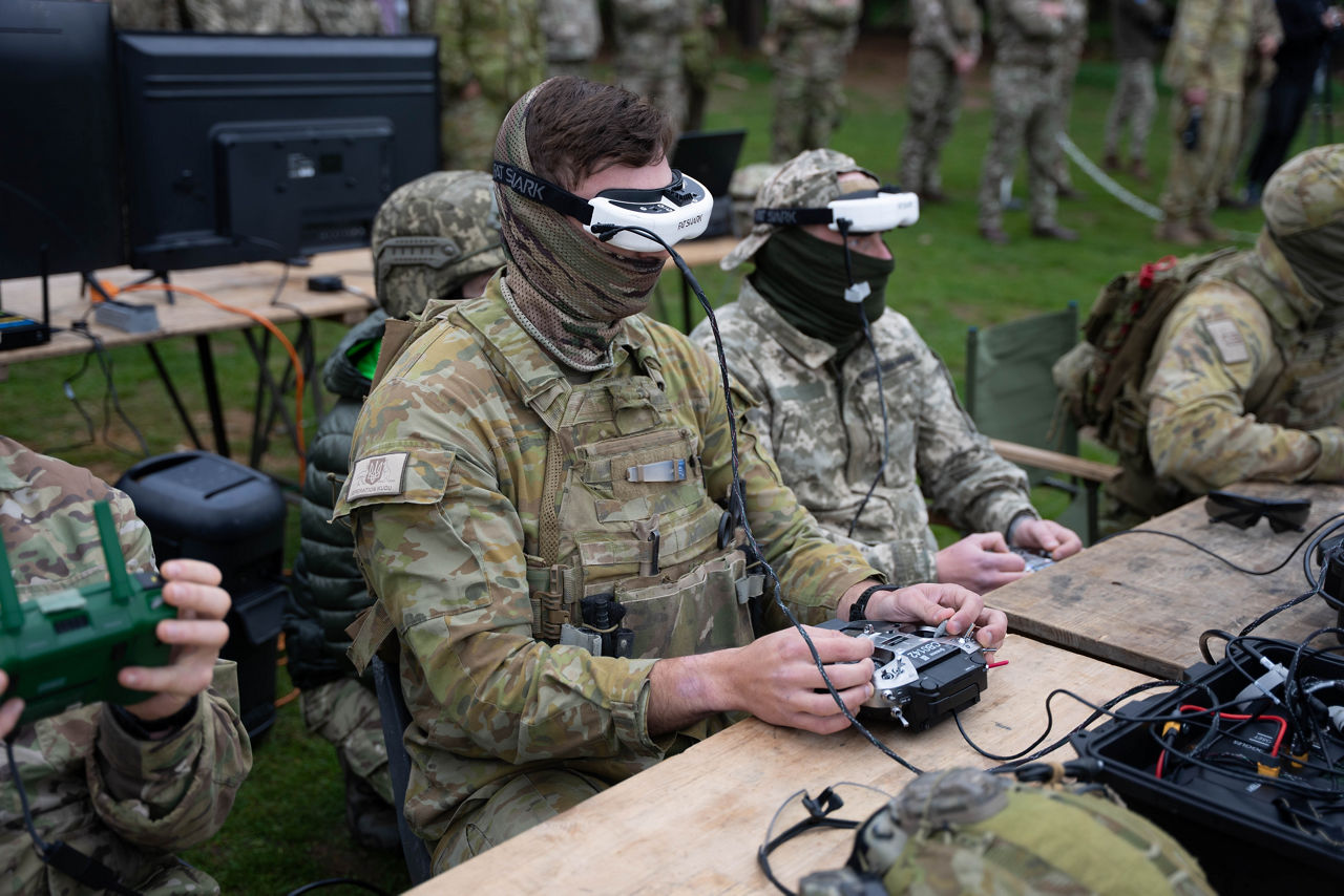 An Australian drone pilot uses an First Person View (FPV)  headset to fly a drone. At an undisclosed location in the United Kingdom, during training exercises as part of Operation Interflex, Ukrainian military personnel shared their experience in using FPV drones in combat operations, which has been in turn used to feed back into the training programme for Ukrainian soldiers. 

The way that the Ukrainians had to fight has changed rapidby over the years since Russia’s full scale invasion, meaning training programmes for Ukrainain soldiers  had to be constantly updated to keep the pace with new threats in the battlefield.