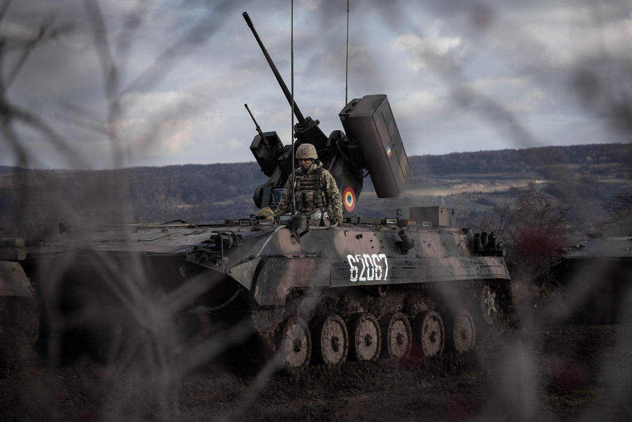 A view of a Romanian MLI-84 infantry fighting vehicle and its crew through foreground of tree branches during Dacian Fall 25. 

NATO forces in Romania demonstrated their ability to expand from a multinational battlegroup to an armoured brigade, quickly absorbing thousands of French Army troops as part of exercise Dacian Fall 25. The drills included troops from Belgium, Bulgaria, France, Germany, Italy, Luxembourg, North Macedonia, Poland, Portugal, Romania, Spain and the United States. It ran from 20 October to 13 November 2025.