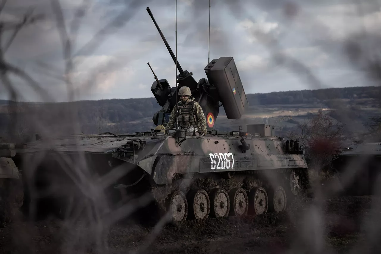 A view of a Romanian MLI-84 infantry fighting vehicle and its crew through foreground of tree branches during Dacian Fall 25. 

NATO forces in Romania demonstrated their ability to expand from a multinational battlegroup to an armoured brigade, quickly absorbing thousands of French Army troops as part of exercise Dacian Fall 25. The drills included troops from Belgium, Bulgaria, France, Germany, Italy, Luxembourg, North Macedonia, Poland, Portugal, Romania, Spain and the United States. It ran from 20 October to 13 November 2025.