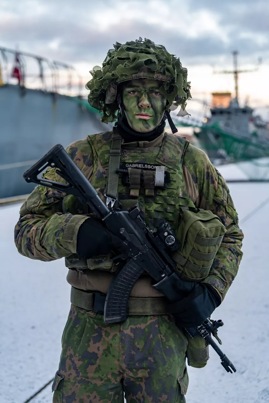 A Finnish conscript on guard duty stands for a photo during exercise Freezing Winds.

NATO and its Allies are intensifying efforts to protect vital sea routes and critical infrastructure. Exercise Freezing Winds 2025 brought together ships from Standing NATO Mine Countermeasures Group One (SNMCMG1) and other Allied units to train side by side in the Baltic Sea’s harsh winter conditions. Over several days, naval forces, divers, and mine counter-measure teams practised joint operations to ensure readiness against diverse threats — from detecting and neutralising underwater threats to responding to disruptions affecting vital sea lines of communication. This exercise complements NATO’s Baltic Sentry enhanced vigilance activity, launched in January 2025 to strengthen surveillance and monitoring across the region. The exercise took place from 24 November to 4 December 2025.