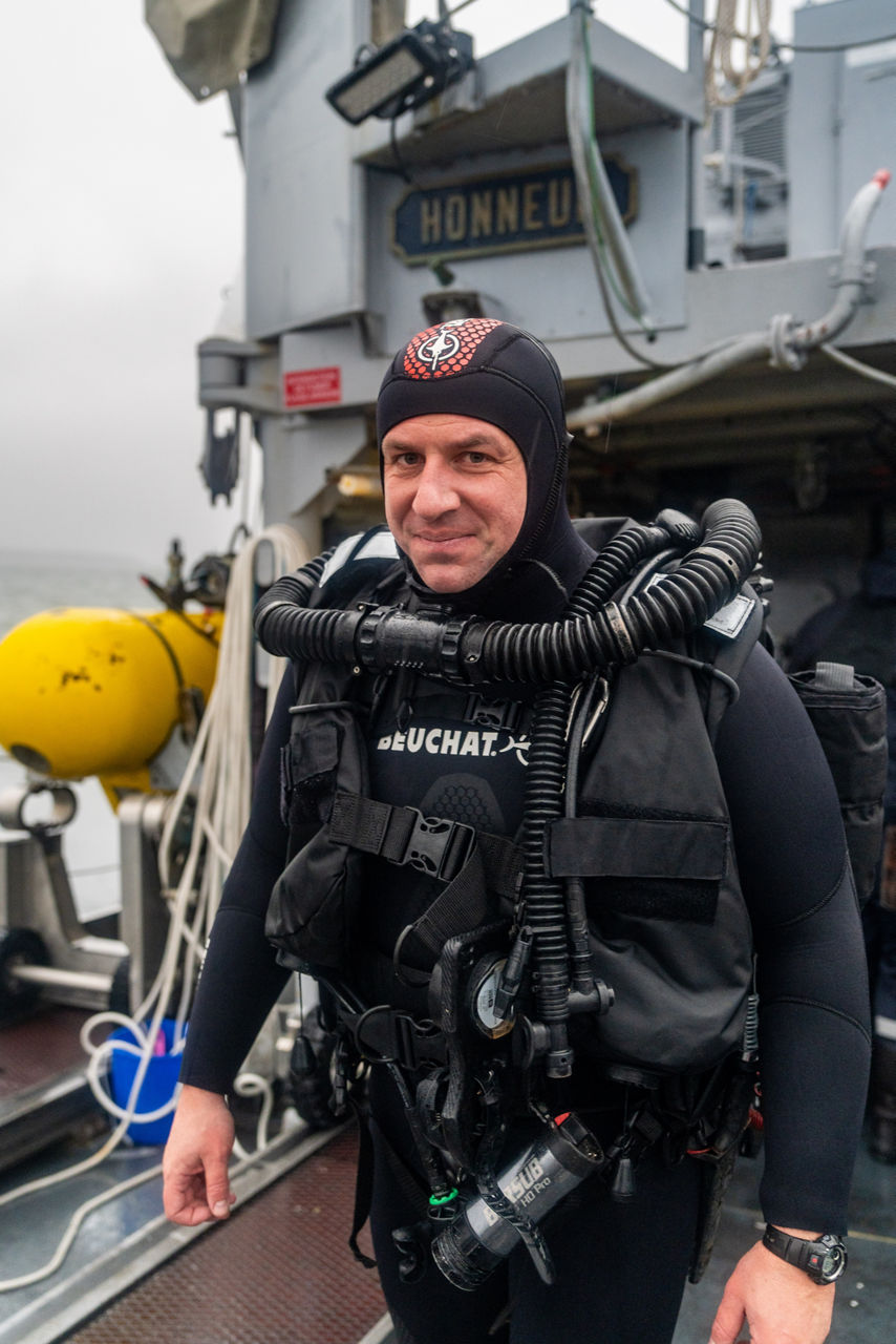 A French diver smiles for the camera while preparing for diving operations on the French minehunter FS Sagittaire during exercise Freezing Winds.

NATO and its Allies are intensifying efforts to protect vital sea routes and critical infrastructure. Exercise Freezing Winds 2025 brought together ships from Standing NATO Mine Countermeasures Group One (SNMCMG1) and other Allied units to train side by side in the Baltic Sea’s harsh winter conditions. Over several days, naval forces, divers, and mine counter-measure teams practised joint operations to ensure readiness against diverse threats — from detecting and neutralising underwater threats to responding to disruptions affecting vital sea lines of communication. This exercise complements NATO’s Baltic Sentry enhanced vigilance activity, launched in January 2025 to strengthen surveillance and monitoring across the region. The exercise took place from 24 November to 4 December 2025.