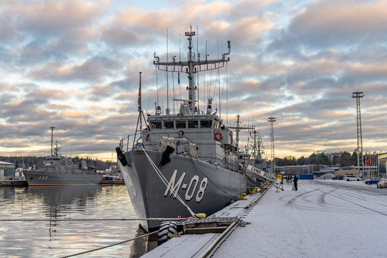 Ships from SNMCMG1 dock at the port of Turku as it prepares for exercise Freezing Winds.

NATO and its Allies are intensifying efforts to protect vital sea routes and critical infrastructure. Exercise Freezing Winds 2025 brought together ships from Standing NATO Mine Countermeasures Group One (SNMCMG1) and other Allied units to train side by side in the Baltic Sea’s harsh winter conditions. Over several days, naval forces, divers, and mine counter-measure teams practised joint operations to ensure readiness against diverse threats — from detecting and neutralising underwater threats to responding to disruptions affecting vital sea lines of communication. This exercise complements NATO’s Baltic Sentry enhanced vigilance activity, launched in January 2025 to strengthen surveillance and monitoring across the region. The exercise took place from 24 November to 4 December 2025.
