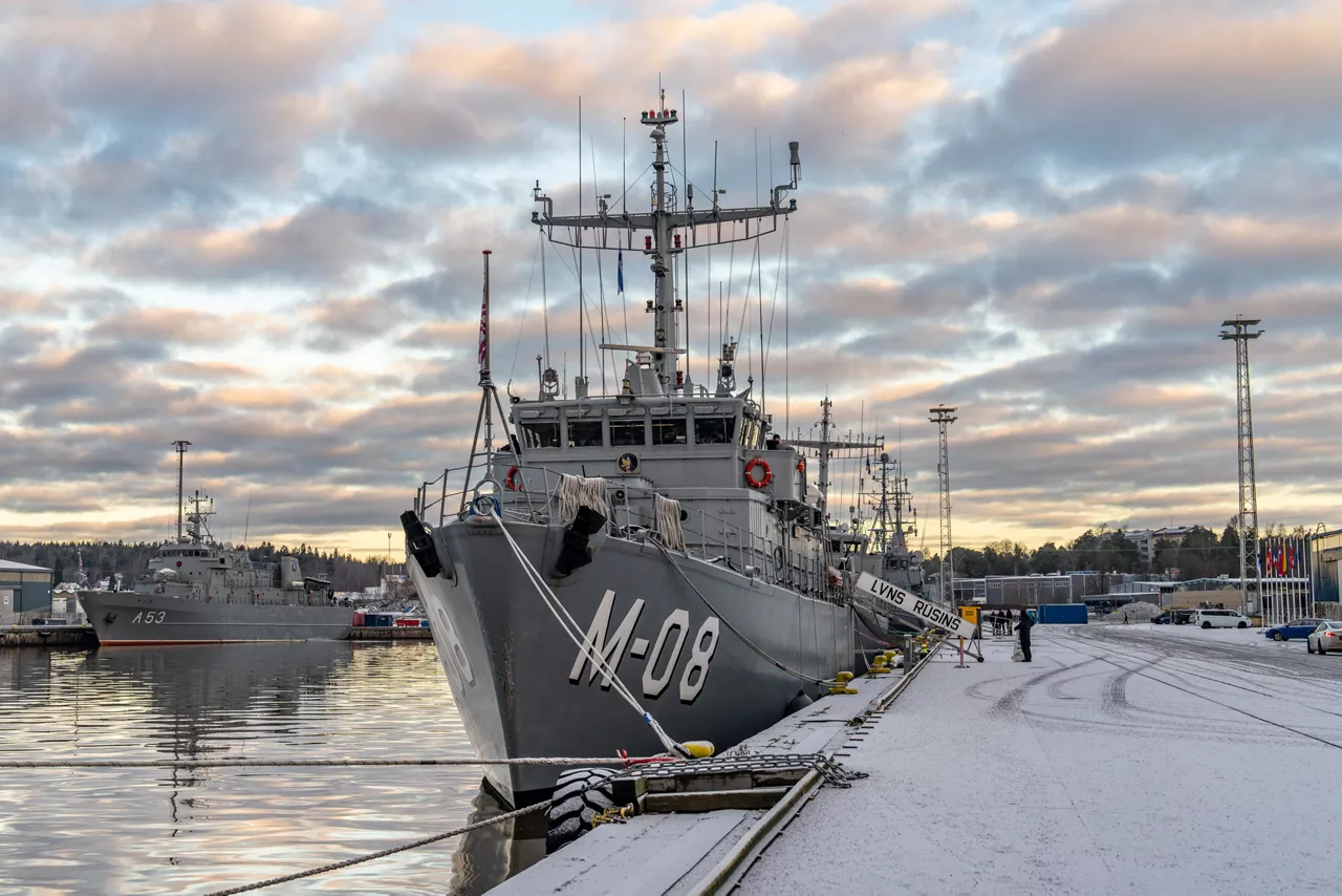 Ships from SNMCMG1 dock at the port of Turku as it prepares for exercise Freezing Winds.

NATO and its Allies are intensifying efforts to protect vital sea routes and critical infrastructure. Exercise Freezing Winds 2025 brought together ships from Standing NATO Mine Countermeasures Group One (SNMCMG1) and other Allied units to train side by side in the Baltic Sea’s harsh winter conditions. Over several days, naval forces, divers, and mine counter-measure teams practised joint operations to ensure readiness against diverse threats — from detecting and neutralising underwater threats to responding to disruptions affecting vital sea lines of communication. This exercise complements NATO’s Baltic Sentry enhanced vigilance activity, launched in January 2025 to strengthen surveillance and monitoring across the region. The exercise took place from 24 November to 4 December 2025.
