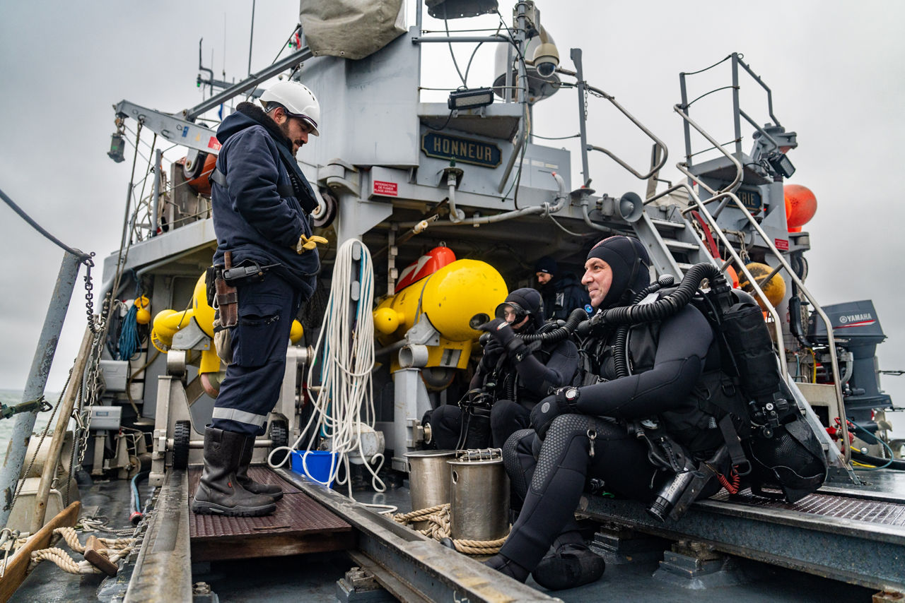 French divers prepare for diving operations on the French minehunter FS Sagittaire during exercise Freezing Winds.

NATO and its Allies are intensifying efforts to protect vital sea routes and critical infrastructure. Exercise Freezing Winds 2025 brought together ships from Standing NATO Mine Countermeasures Group One (SNMCMG1) and other Allied units to train side by side in the Baltic Sea’s harsh winter conditions. Over several days, naval forces, divers, and mine counter-measure teams practised joint operations to ensure readiness against diverse threats — from detecting and neutralising underwater threats to responding to disruptions affecting vital sea lines of communication. This exercise complements NATO’s Baltic Sentry enhanced vigilance activity, launched in January 2025 to strengthen surveillance and monitoring across the region. The exercise took place from 24 November to 4 December 2025.