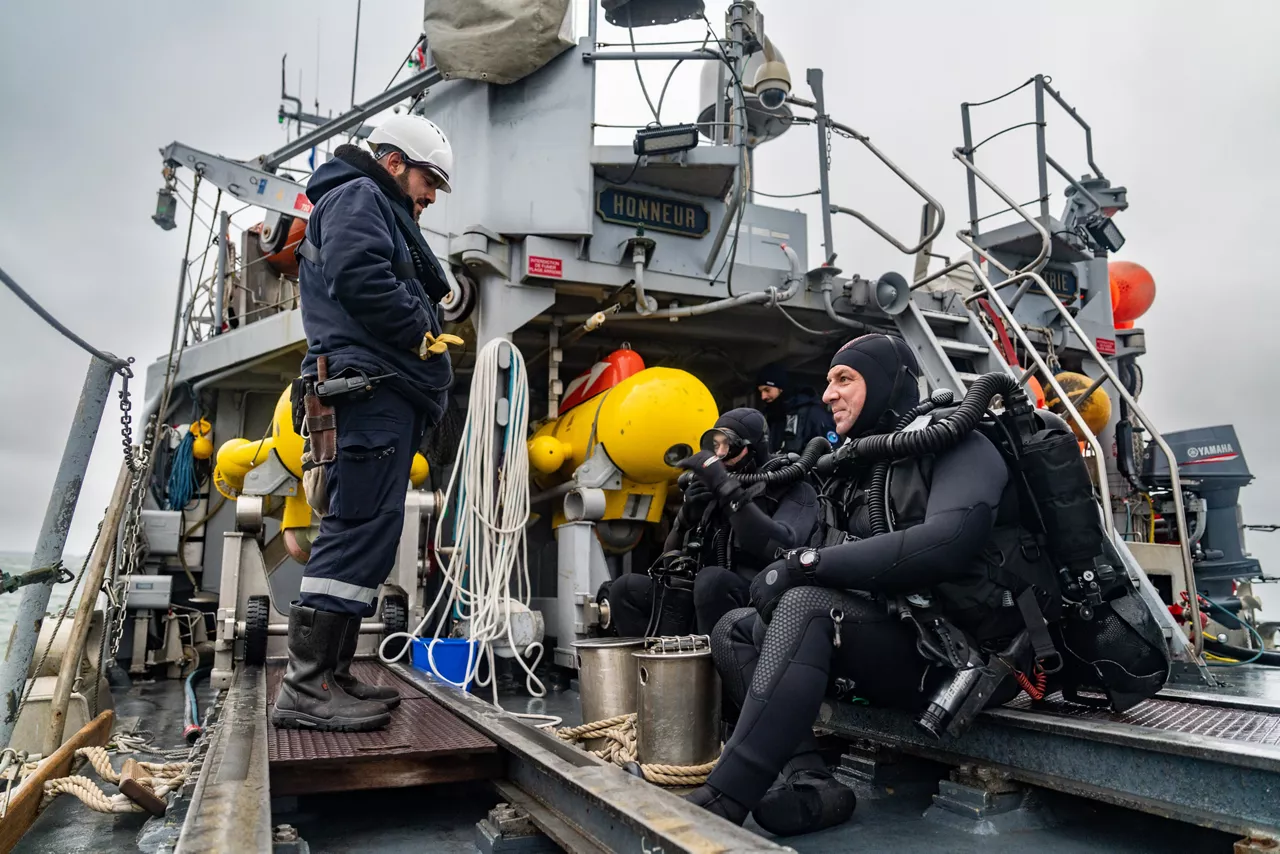 French divers prepare for diving operations on the French minehunter FS Sagittaire during exercise Freezing Winds.

NATO and its Allies are intensifying efforts to protect vital sea routes and critical infrastructure. Exercise Freezing Winds 2025 brought together ships from Standing NATO Mine Countermeasures Group One (SNMCMG1) and other Allied units to train side by side in the Baltic Sea’s harsh winter conditions. Over several days, naval forces, divers, and mine counter-measure teams practised joint operations to ensure readiness against diverse threats — from detecting and neutralising underwater threats to responding to disruptions affecting vital sea lines of communication. This exercise complements NATO’s Baltic Sentry enhanced vigilance activity, launched in January 2025 to strengthen surveillance and monitoring across the region. The exercise took place from 24 November to 4 December 2025.