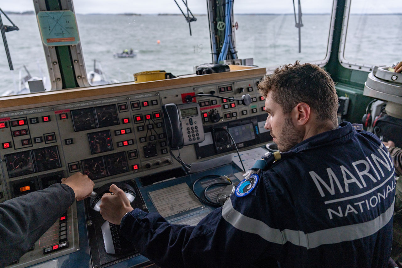 A French sailor sails the French minehunter FS Sagittaire, adjusting the controls on the bridge during exercise Freezing Winds.

NATO and its Allies are intensifying efforts to protect vital sea routes and critical infrastructure. Exercise Freezing Winds 2025 brought together ships from Standing NATO Mine Countermeasures Group One (SNMCMG1) and other Allied units to train side by side in the Baltic Sea’s harsh winter conditions. Over several days, naval forces, divers, and mine counter-measure teams practised joint operations to ensure readiness against diverse threats — from detecting and neutralising underwater threats to responding to disruptions affecting vital sea lines of communication. This exercise complements NATO’s Baltic Sentry enhanced vigilance activity, launched in January 2025 to strengthen surveillance and monitoring across the region. The exercise took place from 24 November to 4 December 2025.
