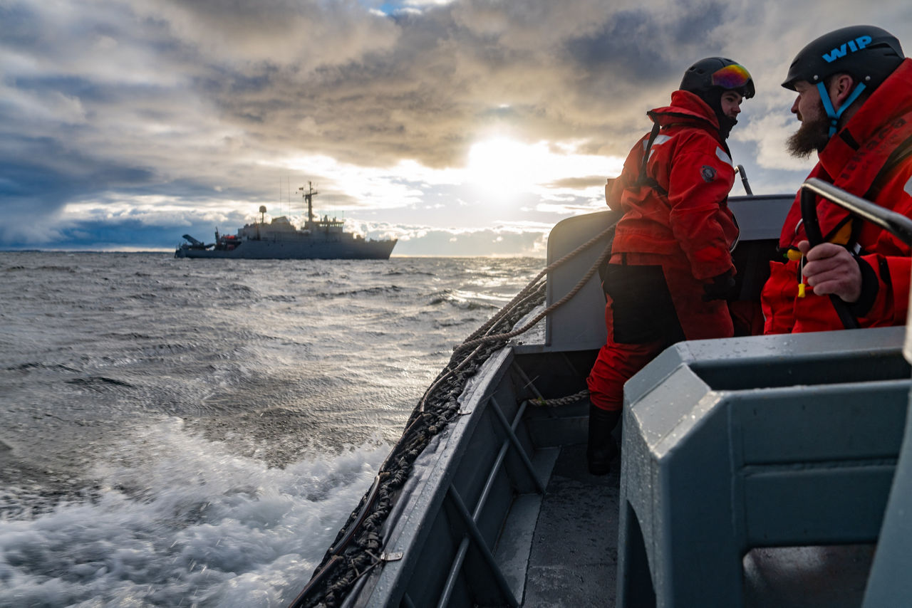 Latvian sailors aboard a RHIB boat sail toward the French minehunter FS Sagittaire during exercise Freezing Winds.

NATO and its Allies are intensifying efforts to protect vital sea routes and critical infrastructure. Exercise Freezing Winds 2025 brought together ships from Standing NATO Mine Countermeasures Group One (SNMCMG1) and other Allied units to train side by side in the Baltic Sea’s harsh winter conditions. Over several days, naval forces, divers, and mine counter-measure teams practised joint operations to ensure readiness against diverse threats — from detecting and neutralising underwater threats to responding to disruptions affecting vital sea lines of communication. This exercise complements NATO’s Baltic Sentry enhanced vigilance activity, launched in January 2025 to strengthen surveillance and monitoring across the region. The exercise took place from 24 November to 4 December 2025.