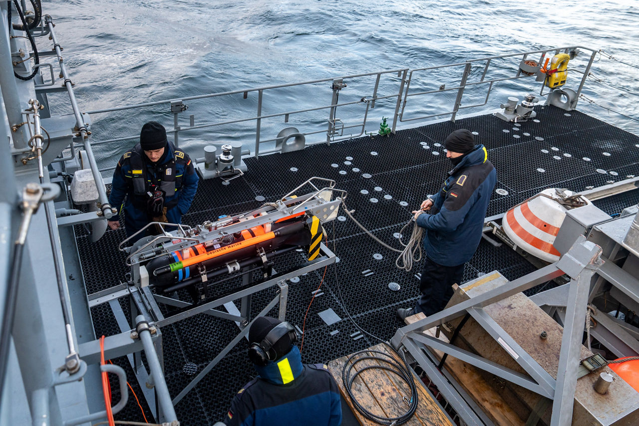German sailors aboard the minehunter FGS Dillingen prepare an underwater drone for mine countermeasure operations during exercise Freezing Winds.

NATO and its Allies are intensifying efforts to protect vital sea routes and critical infrastructure. Exercise Freezing Winds 2025 brought together ships from Standing NATO Mine Countermeasures Group One (SNMCMG1) and other Allied units to train side by side in the Baltic Sea’s harsh winter conditions. Over several days, naval forces, divers, and mine counter-measure teams practised joint operations to ensure readiness against diverse threats — from detecting and neutralising underwater threats to responding to disruptions affecting vital sea lines of communication. This exercise complements NATO’s Baltic Sentry enhanced vigilance activity, launched in January 2025 to strengthen surveillance and monitoring across the region. The exercise took place from 24 November to 4 December 2025.