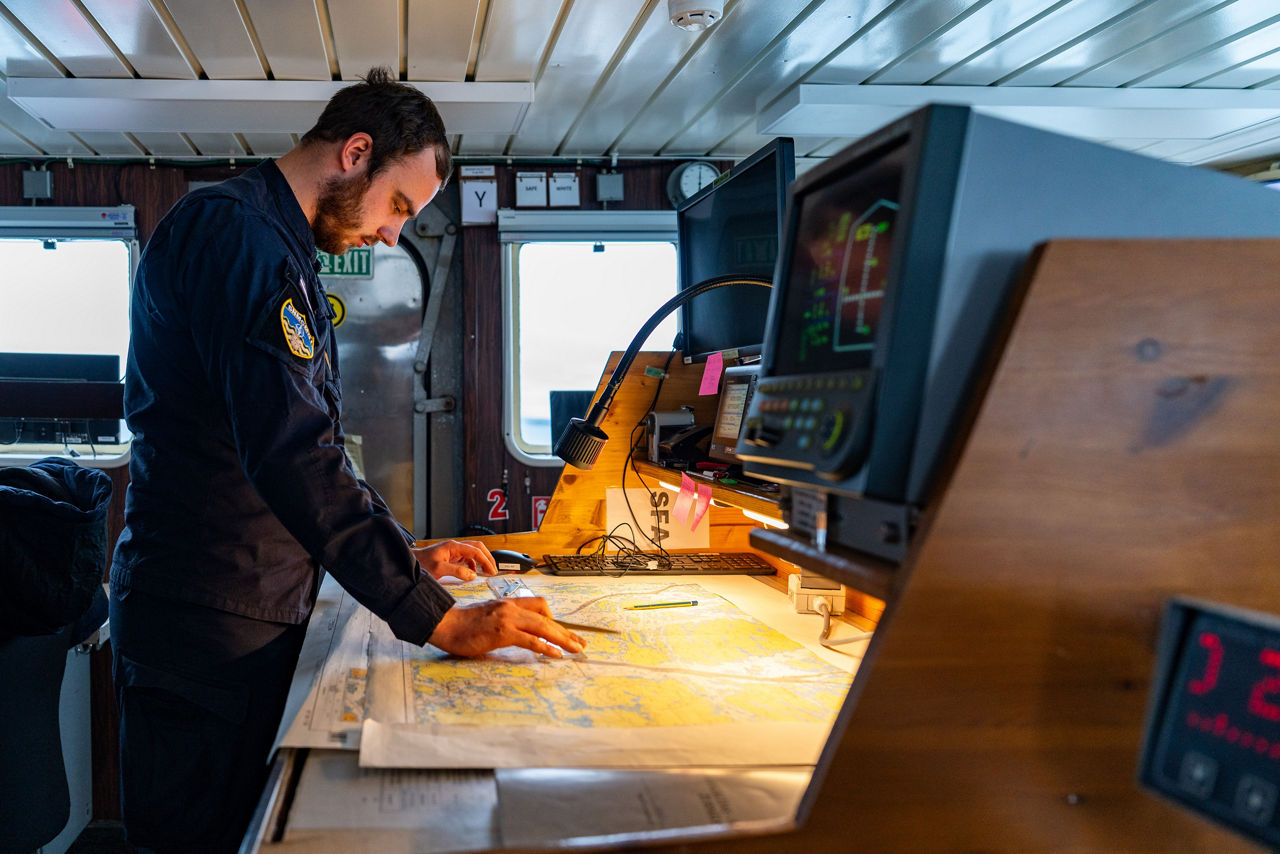 A Latvian sailor aboard SNMCMG1’s flagship LVNS Virsaitis studies a map while sailing during exercise Freezing Winds.

NATO and its Allies are intensifying efforts to protect vital sea routes and critical infrastructure. Exercise Freezing Winds 2025 brought together ships from Standing NATO Mine Countermeasures Group One (SNMCMG1) and other Allied units to train side by side in the Baltic Sea’s harsh winter conditions. Over several days, naval forces, divers, and mine counter-measure teams practised joint operations to ensure readiness against diverse threats — from detecting and neutralising underwater threats to responding to disruptions affecting vital sea lines of communication. This exercise complements NATO’s Baltic Sentry enhanced vigilance activity, launched in January 2025 to strengthen surveillance and monitoring across the region. The exercise took place from 24 November to 4 December 2025.