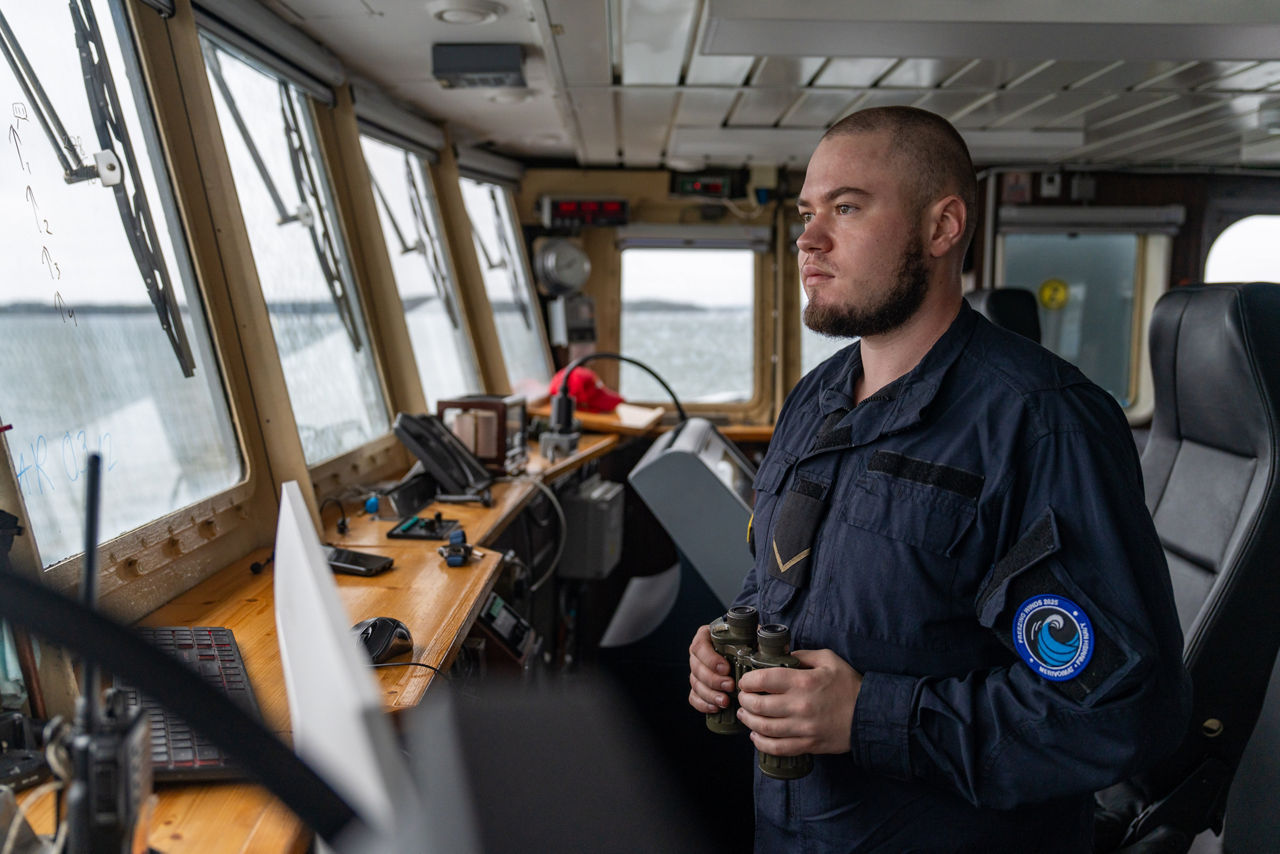 A Latvian sailor looks out from the bridge of SNMCMG1’s flagship, LVNS Virsaitis, as it sails during exercise Freezing Winds.

NATO and its Allies are intensifying efforts to protect vital sea routes and critical infrastructure. Exercise Freezing Winds 2025 brought together ships from Standing NATO Mine Countermeasures Group One (SNMCMG1) and other Allied units to train side by side in the Baltic Sea’s harsh winter conditions. Over several days, naval forces, divers, and mine counter-measure teams practised joint operations to ensure readiness against diverse threats — from detecting and neutralising underwater threats to responding to disruptions affecting vital sea lines of communication. This exercise complements NATO’s Baltic Sentry enhanced vigilance activity, launched in January 2025 to strengthen surveillance and monitoring across the region. The exercise took place from 24 November to 4 December 2025.