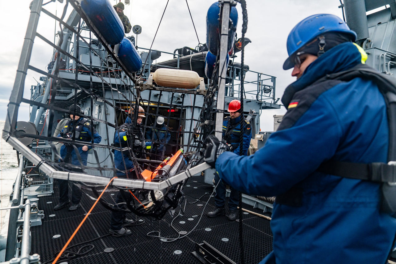 German sailors aboard the minehunter FGS Dillingen retrieve an underwater drone after mine countermeasure operations during exercise Freezing Winds.

NATO and its Allies are intensifying efforts to protect vital sea routes and critical infrastructure. Exercise Freezing Winds 2025 brought together ships from Standing NATO Mine Countermeasures Group One (SNMCMG1) and other Allied units to train side by side in the Baltic Sea’s harsh winter conditions. Over several days, naval forces, divers, and mine counter-measure teams practised joint operations to ensure readiness against diverse threats — from detecting and neutralising underwater threats to responding to disruptions affecting vital sea lines of communication. This exercise complements NATO’s Baltic Sentry enhanced vigilance activity, launched in January 2025 to strengthen surveillance and monitoring across the region. The exercise took place from 24 November to 4 December 2025.