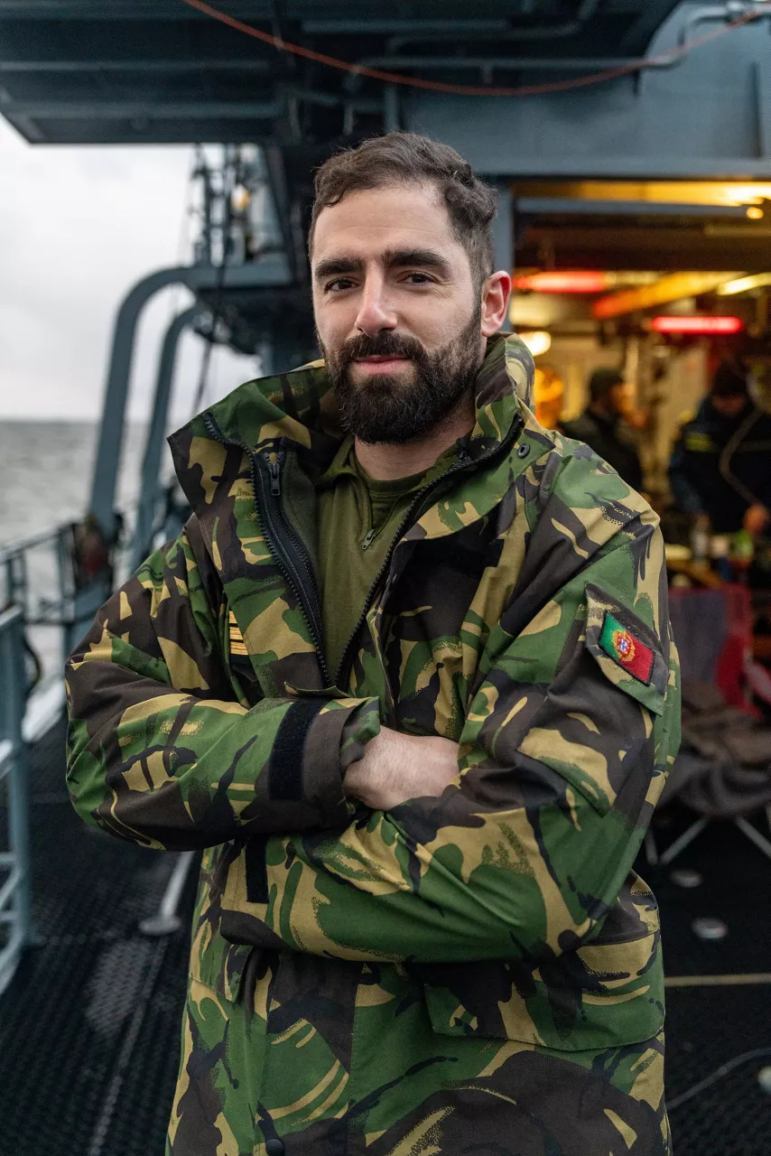 A Portuguese diver smiles at the camera after completing underwater operations during exercise Freezing Winds, deployed from the German minehunter FGS Dillingen.

NATO and its Allies are intensifying efforts to protect vital sea routes and critical infrastructure. Exercise Freezing Winds 2025 brought together ships from Standing NATO Mine Countermeasures Group One (SNMCMG1) and other Allied units to train side by side in the Baltic Sea’s harsh winter conditions. Over several days, naval forces, divers, and mine counter-measure teams practised joint operations to ensure readiness against diverse threats — from detecting and neutralising underwater threats to responding to disruptions affecting vital sea lines of communication. This exercise complements NATO’s Baltic Sentry enhanced vigilance activity, launched in January 2025 to strengthen surveillance and monitoring across the region. The exercise took place from 24 November to 4 December 2025.