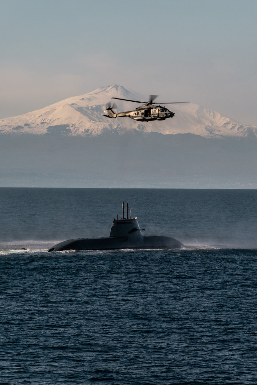 An Italian Navy helicopter hovers over an Italian Navy submarine during Exercise Dynamic Manta 26. The exercise, held annually by NATO Allied Maritime Command, tests Allied Anti-Submarine Warfare capabilities in a series of sub-hunting drills off the coast of Sicily. This year’s iteration gathered ship, submarines and aircraft from nine Allies, including Canada, France, Germany, Greece, Italy, Portugal, Turkey, the United Kingdom and the United States.