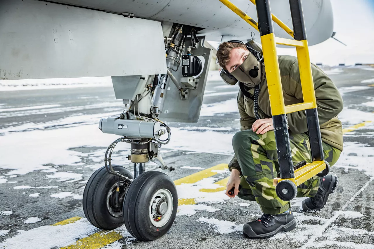 A Swedish Air Force aircraft maintainer inspects the landing gear of a JAS 39 Gripen fighter at Keflavik Air Base in Iceland while deployed as part of NATO’s Arctic Sentry activity. Arctic Sentry is a NATO vigilance activity aimed at enhancing security in the north, helping to make the Alliance safer. As part of this initiative, Sweden deployed a detachment of six Gripens to Keflavik Air Base to safeguard Icelandic airspace against threats or intrusions. Their deployment is also part of NATO’s Iceland Air Policing mission, marking the first time Sweden has led an air policing mission since joining NATO two years ago as its 32nd member. Situated in the middle of the North Atlantic, Iceland plays a vital role in helping Allies maintain situational awareness in the High North. Photo courtesy of NATO Allied Air Command.