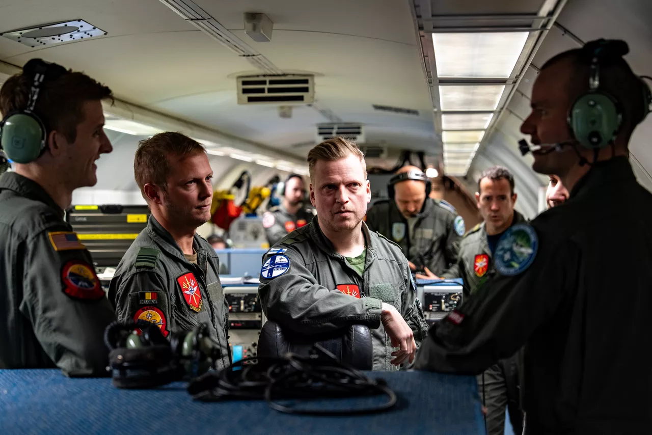 Aircrew from Belgium, Finland and the United States discuss the mission on board a NATO E‑3A Airborne Warning and Control System (AWACS) aircraft.

NATO’s Airborne Warning and Control System (AWACS) launched its first surveillance flight over the Barents Sea on 6 March 2026 in support of the enhanced vigilance activity “Arctic Sentry.” Arctic Sentry brings together exercises, troops and capabilities from several NATO Allies across the Arctic and the High North. By boosting surveillance and sharpening joint readiness, ”Arctic Sentry”  helps ensure that NATO and Allies can respond together to challenges in one of the world’s most strategically important regions.