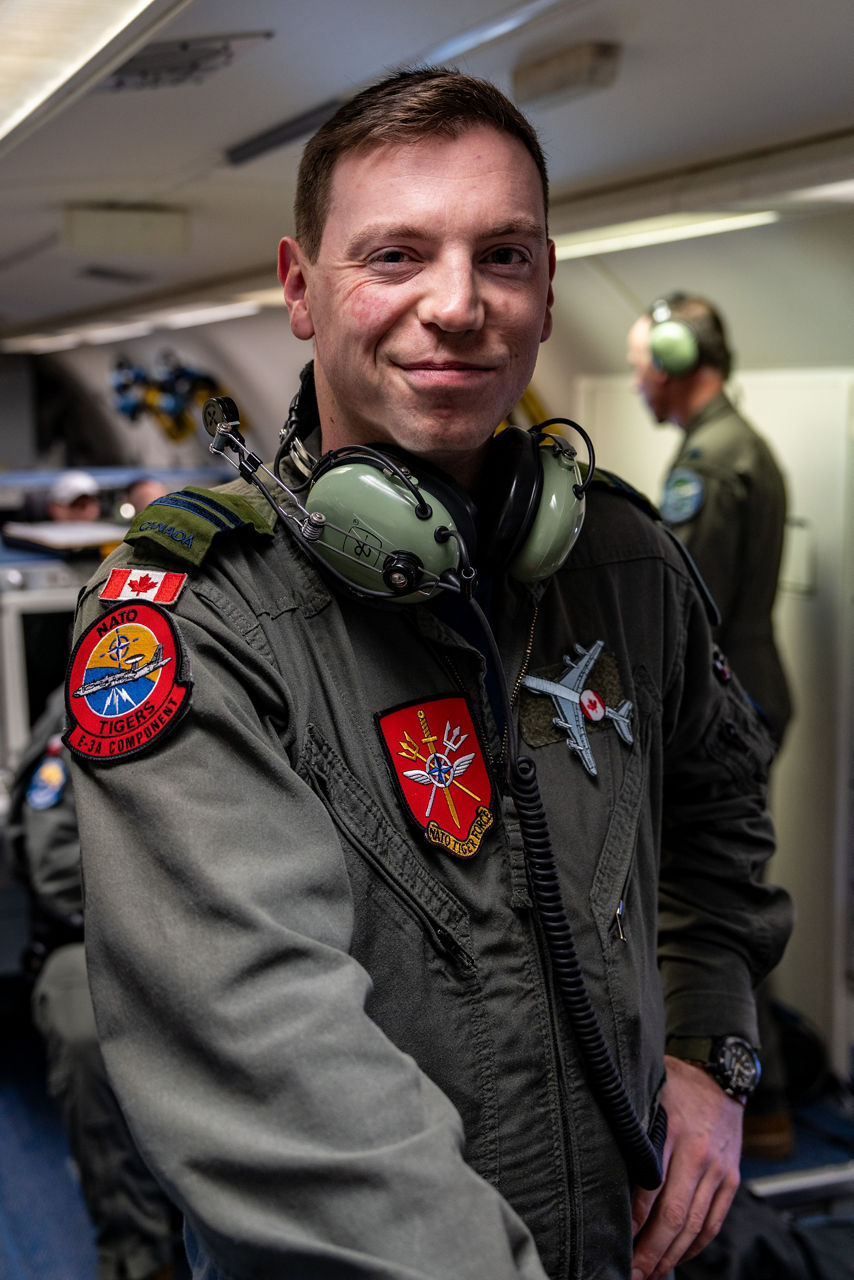 A Canadian aircrew member smiles to the camera aboard a NATO E‑3A Airborne Warning and Control System (AWACS) aircraft.

NATO’s Airborne Warning and Control System (AWACS) launched its first surveillance flight over the Barents Sea on 6 March 2026 in support of the enhanced vigilance activity “Arctic Sentry.” Arctic Sentry brings together exercises, troops and capabilities from several NATO Allies across the Arctic and the High North. By boosting surveillance and sharpening joint readiness, ”Arctic Sentry”  helps ensure that NATO and Allies can respond together to challenges in one of the world’s most strategically important regions.