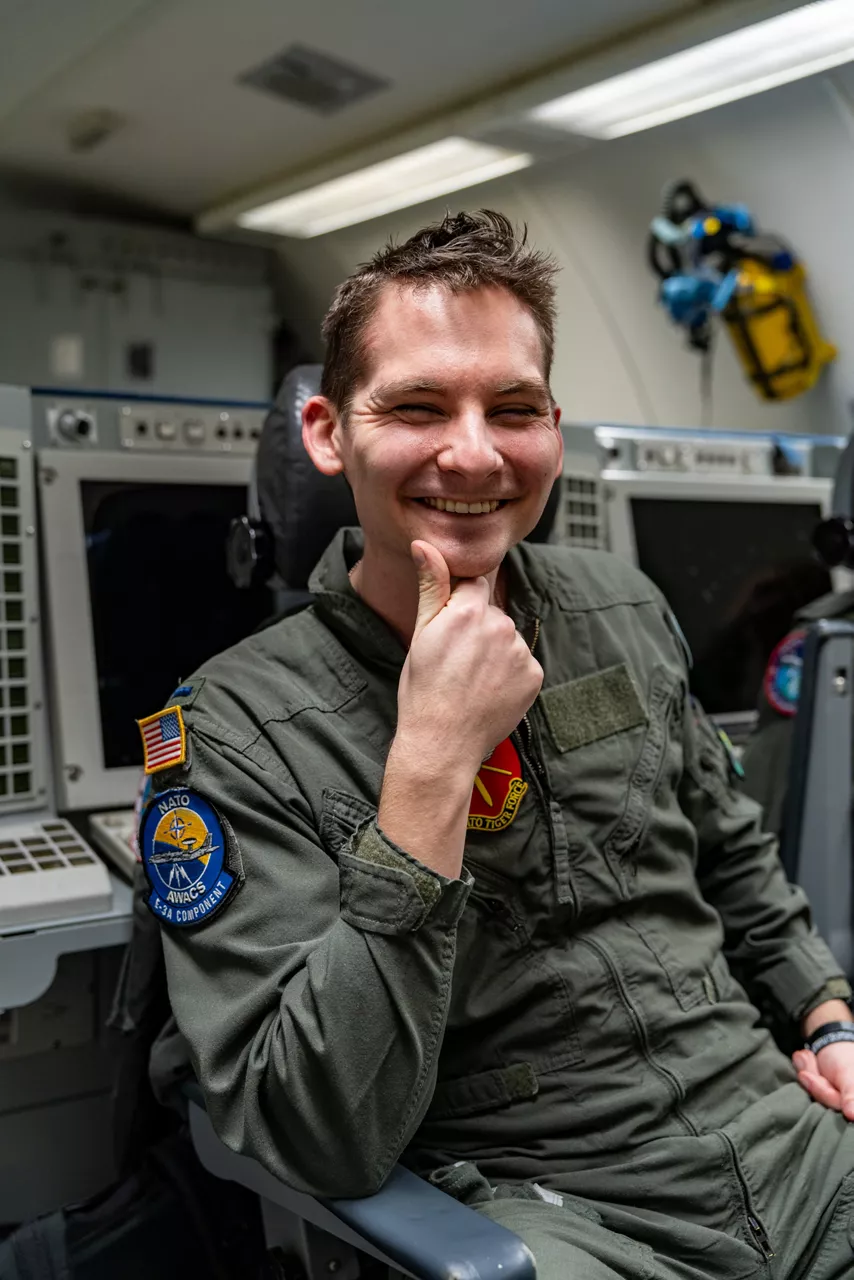 A United States aircrew member smiles to the camera aboard a NATO E‑3A Airborne Warning and Control System (AWACS) aircraft.

NATO’s Airborne Warning and Control System (AWACS) launched its first surveillance flight over the Barents Sea on 6 March 2026 in support of the enhanced vigilance activity “Arctic Sentry.” Arctic Sentry brings together exercises, troops and capabilities from several NATO Allies across the Arctic and the High North. By boosting surveillance and sharpening joint readiness, ”Arctic Sentry”  helps ensure that NATO and Allies can respond together to challenges in one of the world’s most strategically important regions.