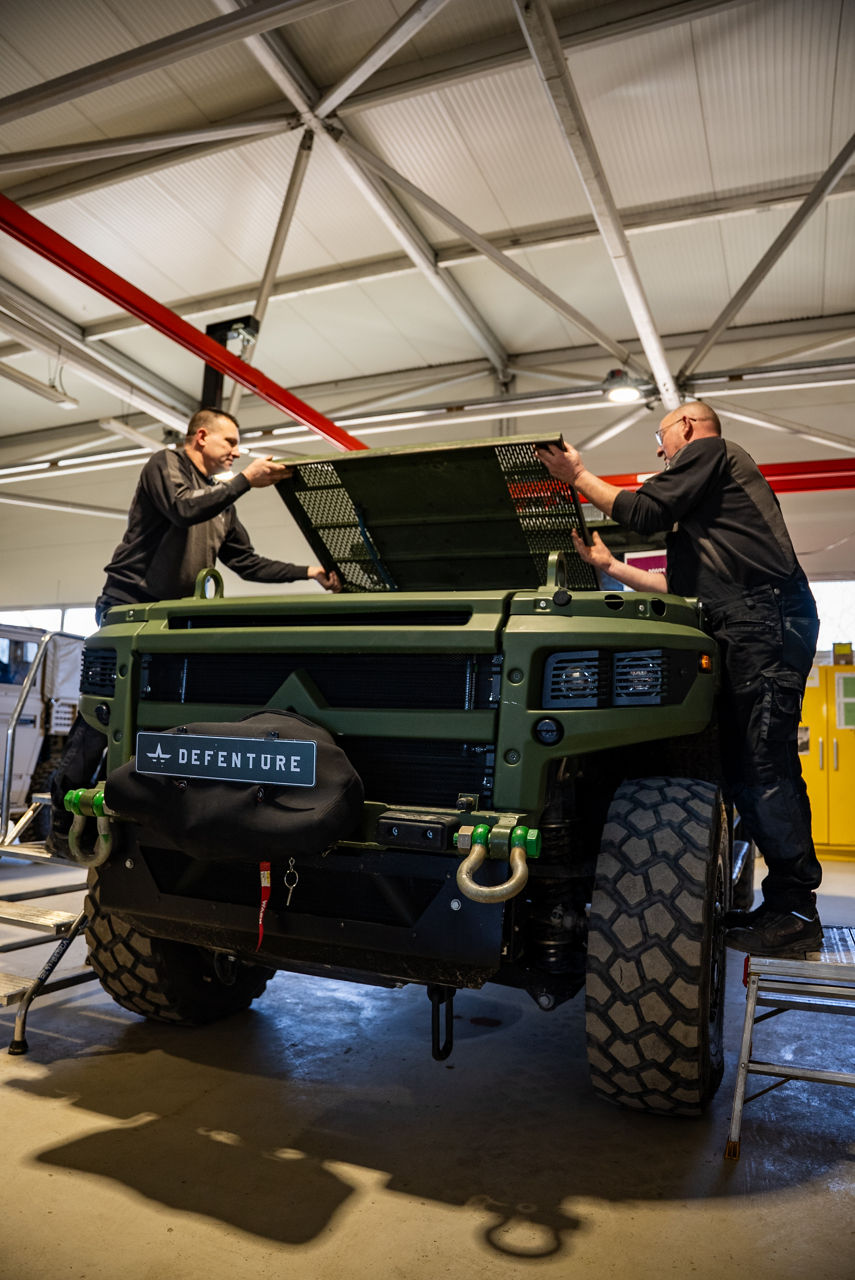Workers fit an engine cover on a Mammoth vehicle. Larger than the GRF, the Mammoth also features 4 wheel steering. As NATO members ramp up defence spending, Europe’s defence industrial base is stepping up to meet demand. Defenture, a defence company founded in 2013 and headquartered in Tiel, the Netherlands, specialises in producing light tactical mobility solutions. Vehicles designed not just for transport, but for survivability and flexibility. 
Engineers, technicians, and assembly teams work side by side, transforming raw components into mission-ready vehicles, including the lightweight and maneuverable GRF and the powerful Mammoth. These vehicles are destined for use with various NATO allies including Germany and Lithuania.