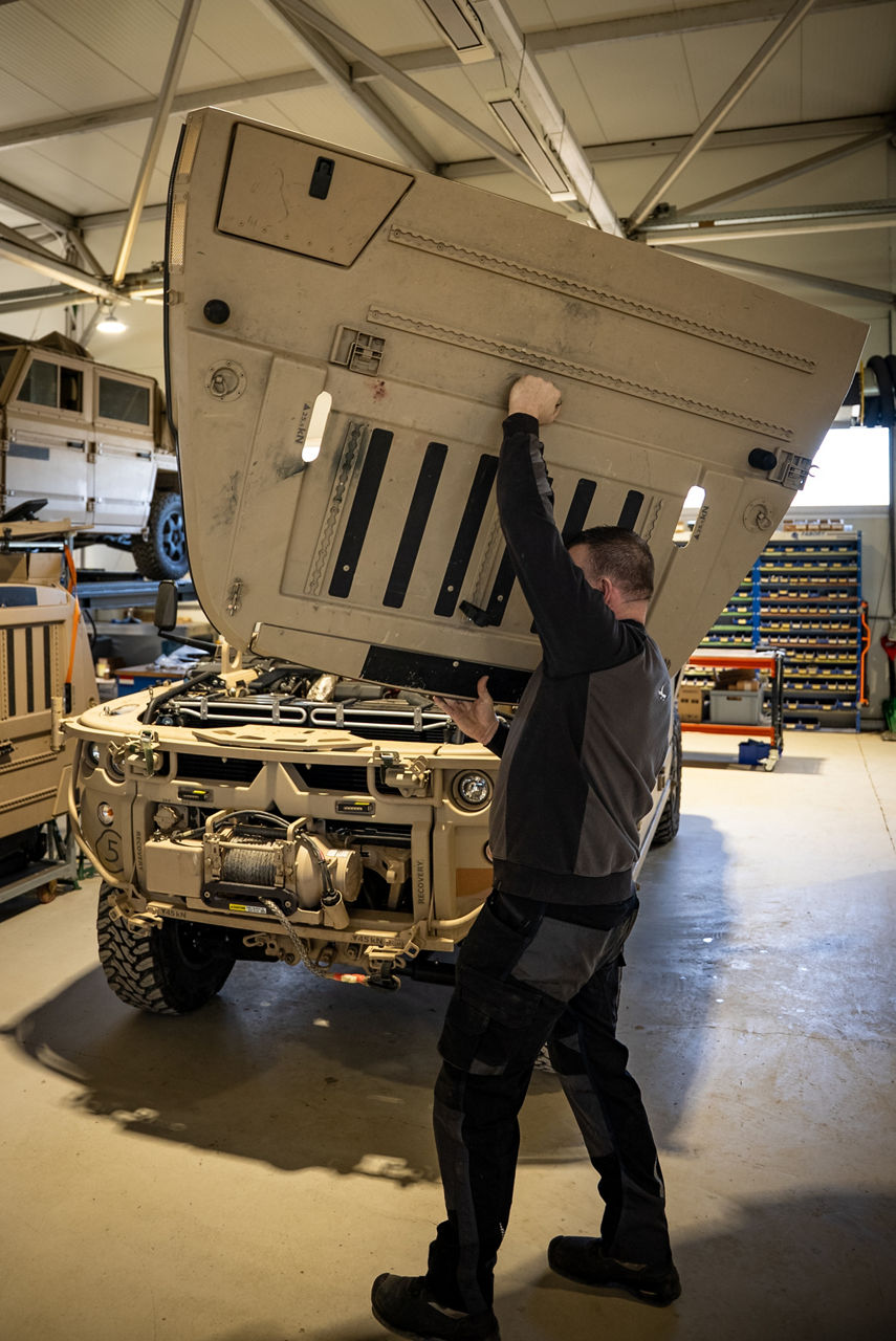 A worker lifts an engine cover on a GRF tactical vehicle. As NATO members ramp up defence spending, Europe’s defence industrial base is stepping up to meet demand. Defenture, a defence company founded in 2013 and headquartered in Tiel, the Netherlands, specialises in producing light tactical mobility solutions. Vehicles designed not just for transport, but for survivability and flexibility. 
Engineers, technicians, and assembly teams work side by side, transforming raw components into mission-ready vehicles, including the lightweight and maneuverable GRF and the powerful Mammoth. These vehicles are destined for use with various NATO allies including Germany and Lithuania.