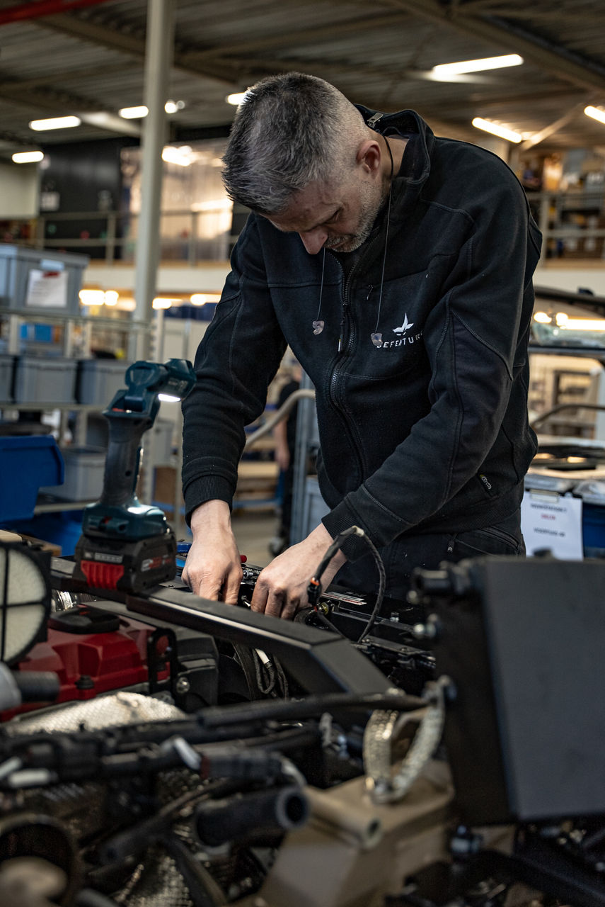 A worker fits components to the engine bay of a GRF tactical vehicle. As NATO members ramp up defence spending, Europe’s defence industrial base is stepping up to meet demand. Defenture, a defence company founded in 2013 and headquartered in Tiel, the Netherlands, specialises in producing light tactical mobility solutions. Vehicles designed not just for transport, but for survivability and flexibility. 
Engineers, technicians, and assembly teams work side by side, transforming raw components into mission-ready vehicles, including the lightweight and maneuverable GRF and the powerful Mammoth. These vehicles are destined for use with various NATO allies including Germany and Lithuania.