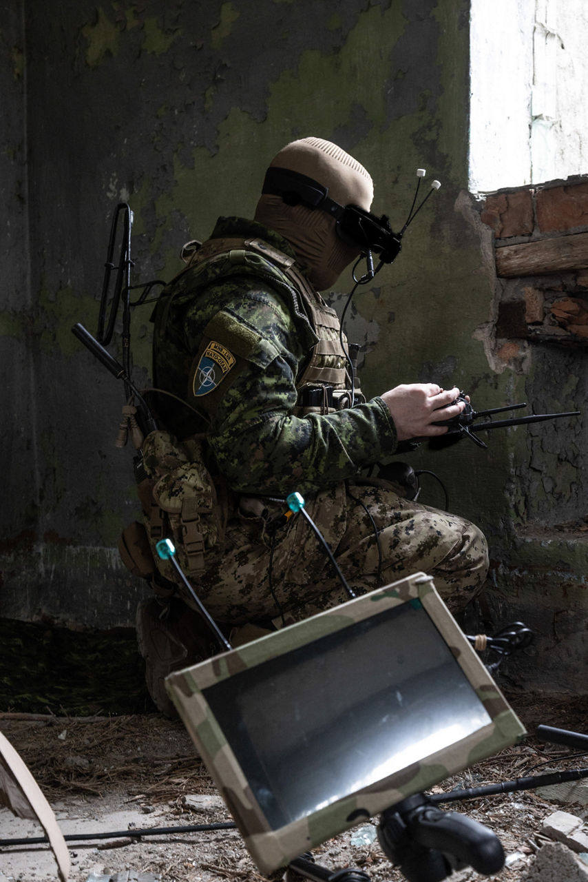 A Canadian Armed Forces drone pilot operating an FPV drone from an abandoned building. NATO’s Multinational Brigade in Latvia regularly runs training exercises where troops integrate drones of all kinds, making sure Allied forces keep pace with innovations in modern wafare.