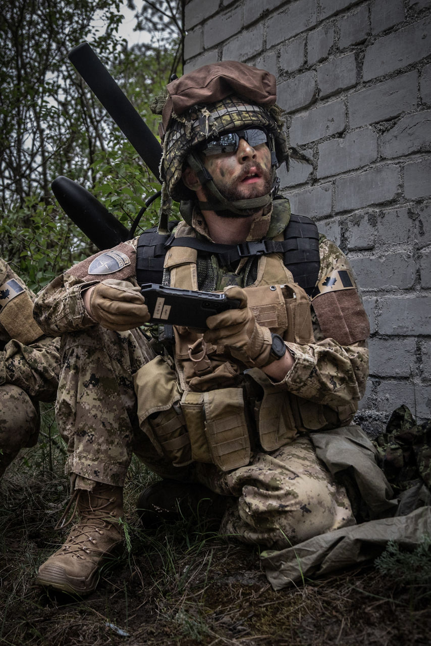 A Canadian Armed Forces counter drone specialist observing a drone overhead. NATO’s Multinational Brigade in Latvia regularly runs training exercises where troops integrate all kinds of drones, making sure Allied forces keep up with innovations in modern warfare.