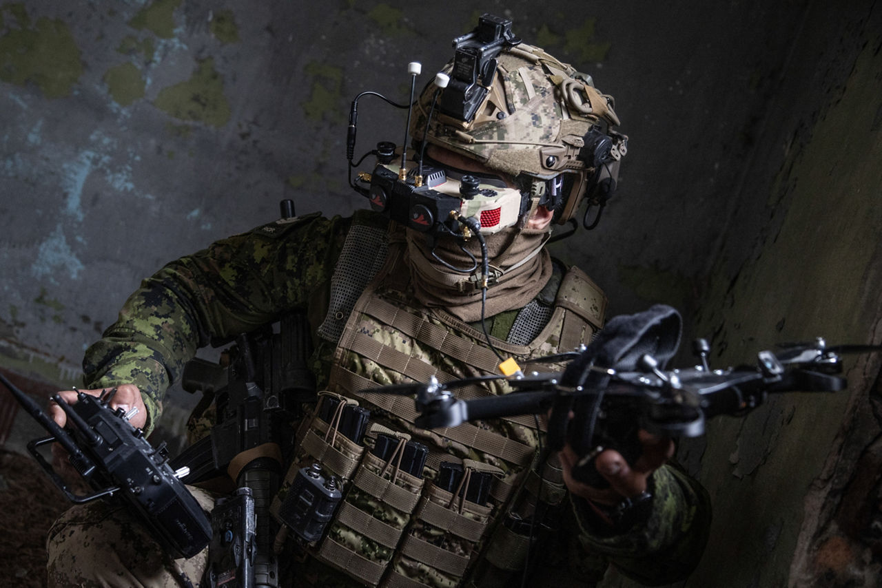 A Canadian drone pilot holding an FPV drone. NATO’s Multinational Brigade in Latvia regularly runs training exercises where troops integrate all kinds of drones, making sure Allied forces keep up with innovations in modern warfare.